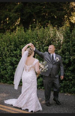 Bride with groom wearing a lace cap sleeve wedding dress