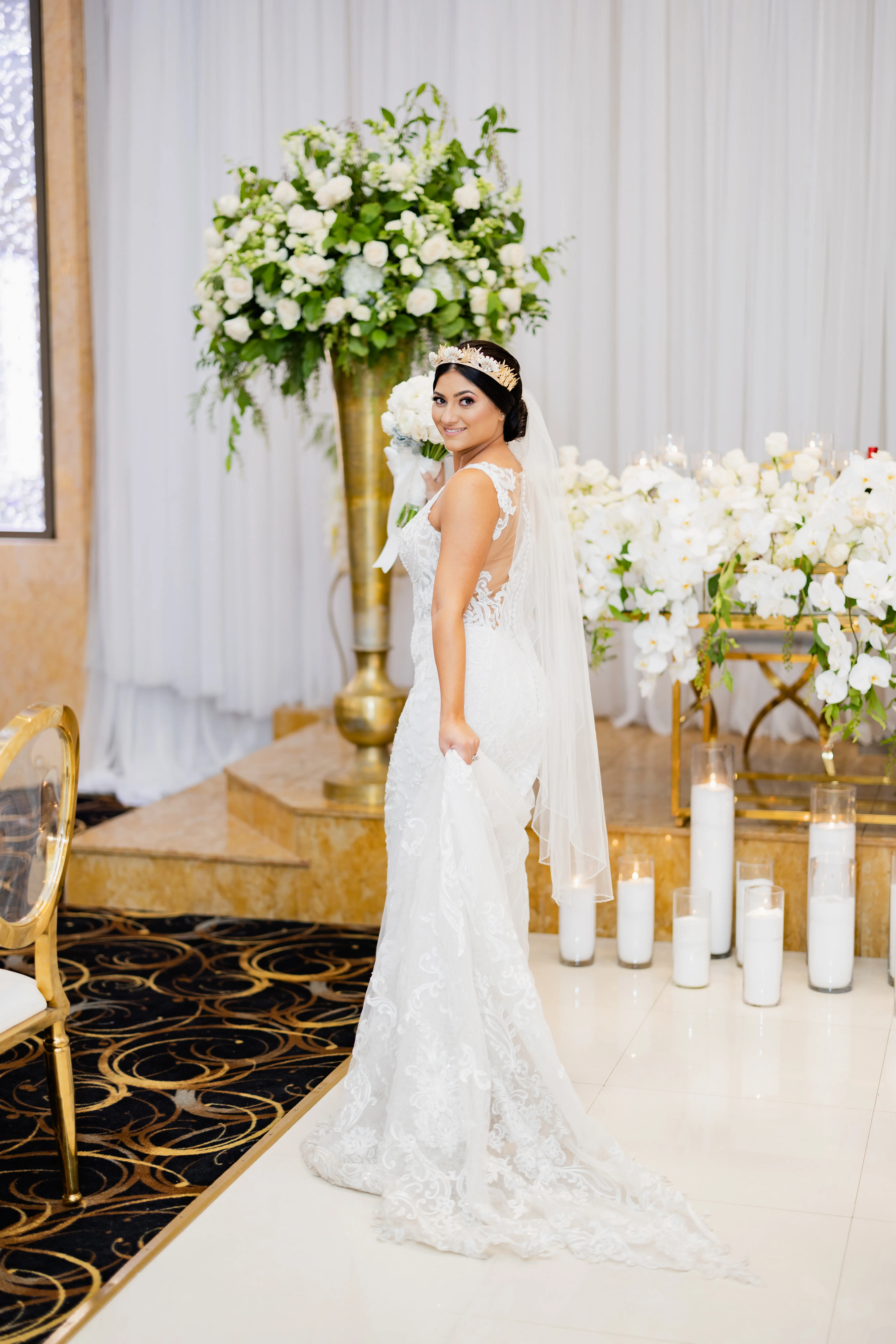 Bride Wearing Vintage Inspired Dramatic Back Wedding Dress Called Hamilton By Sottero And Midgley Holding Skirt By Candles