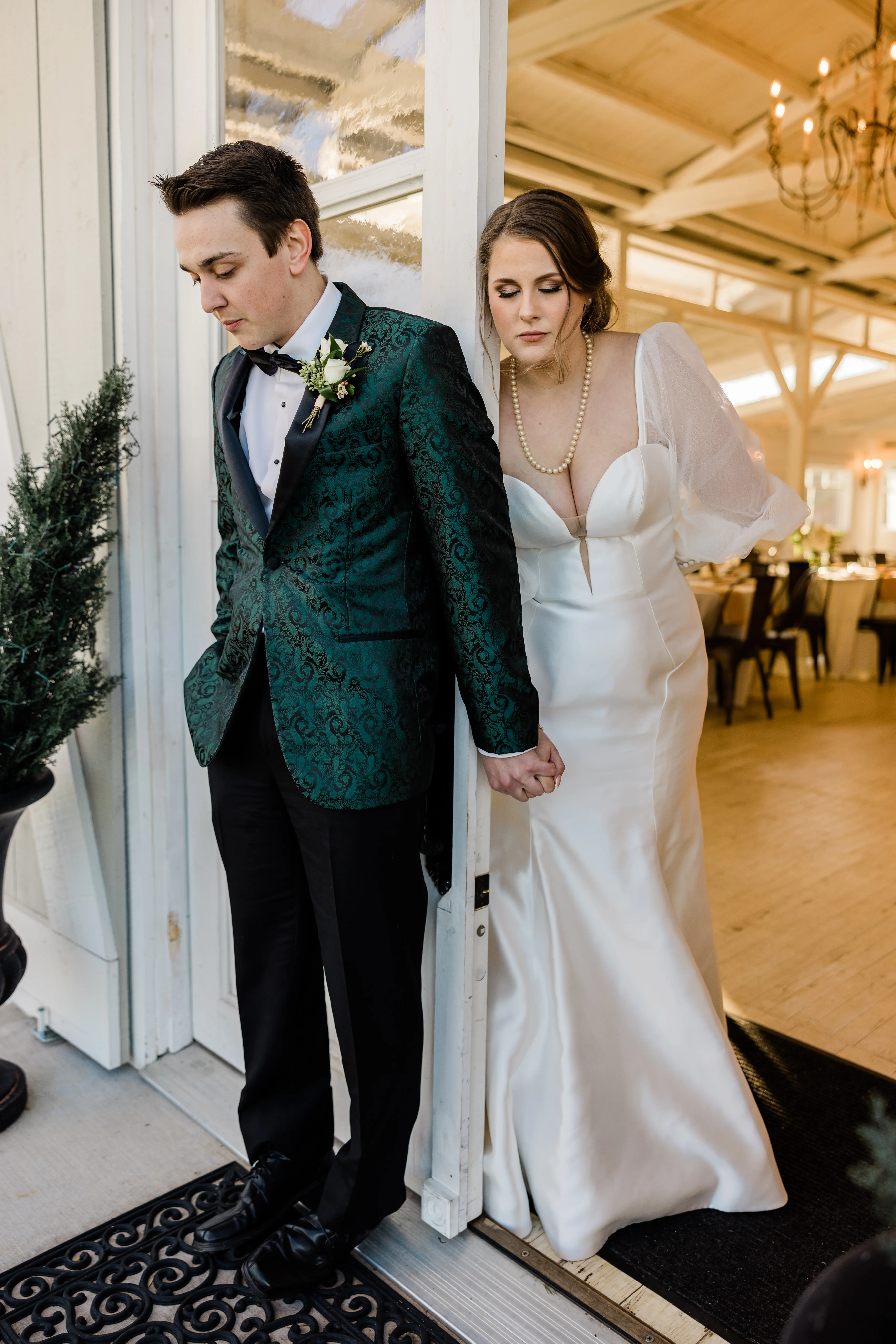 Groom And Bride Share First Touch. Bride Wearing Mikado Mermaid Dress With Plunging Neckline Called Pippa By Rebecca Ingram