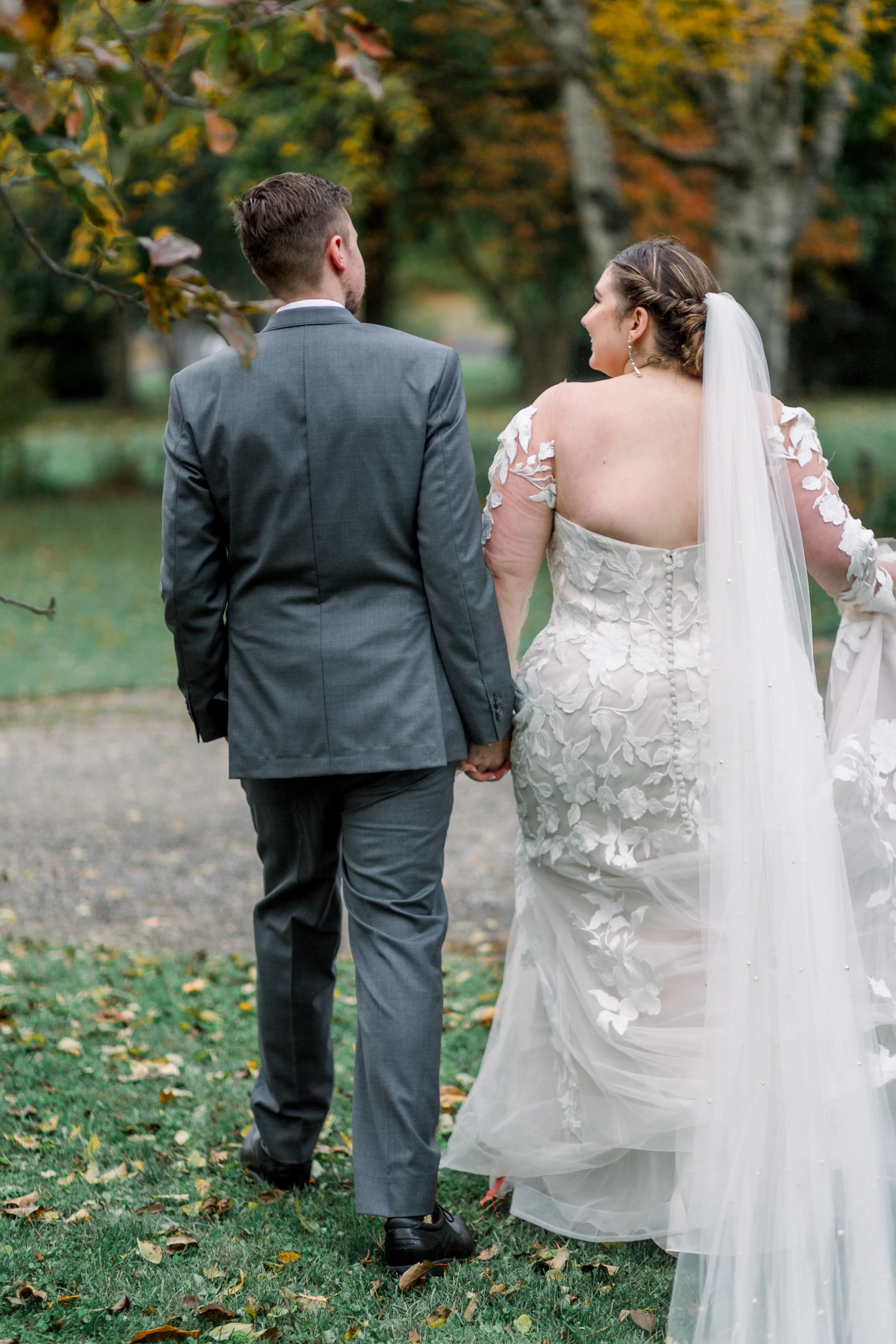 Bride wearing Hattie by Rebecca Ingram walking with her husband