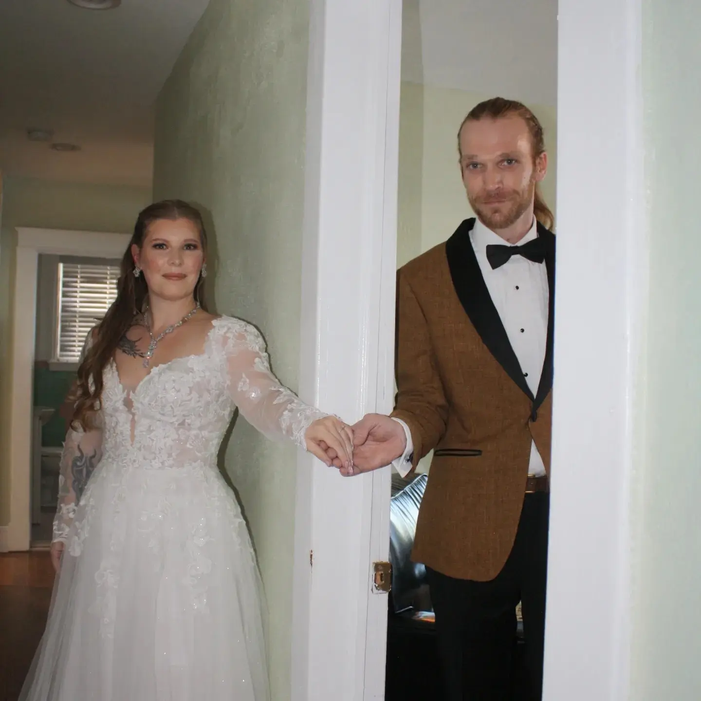 Bride Wearing Princess Wedding Dress With Long Sleeves Called Stevie By Maggie Sottero Holding Hands With Groom Before Ceremony