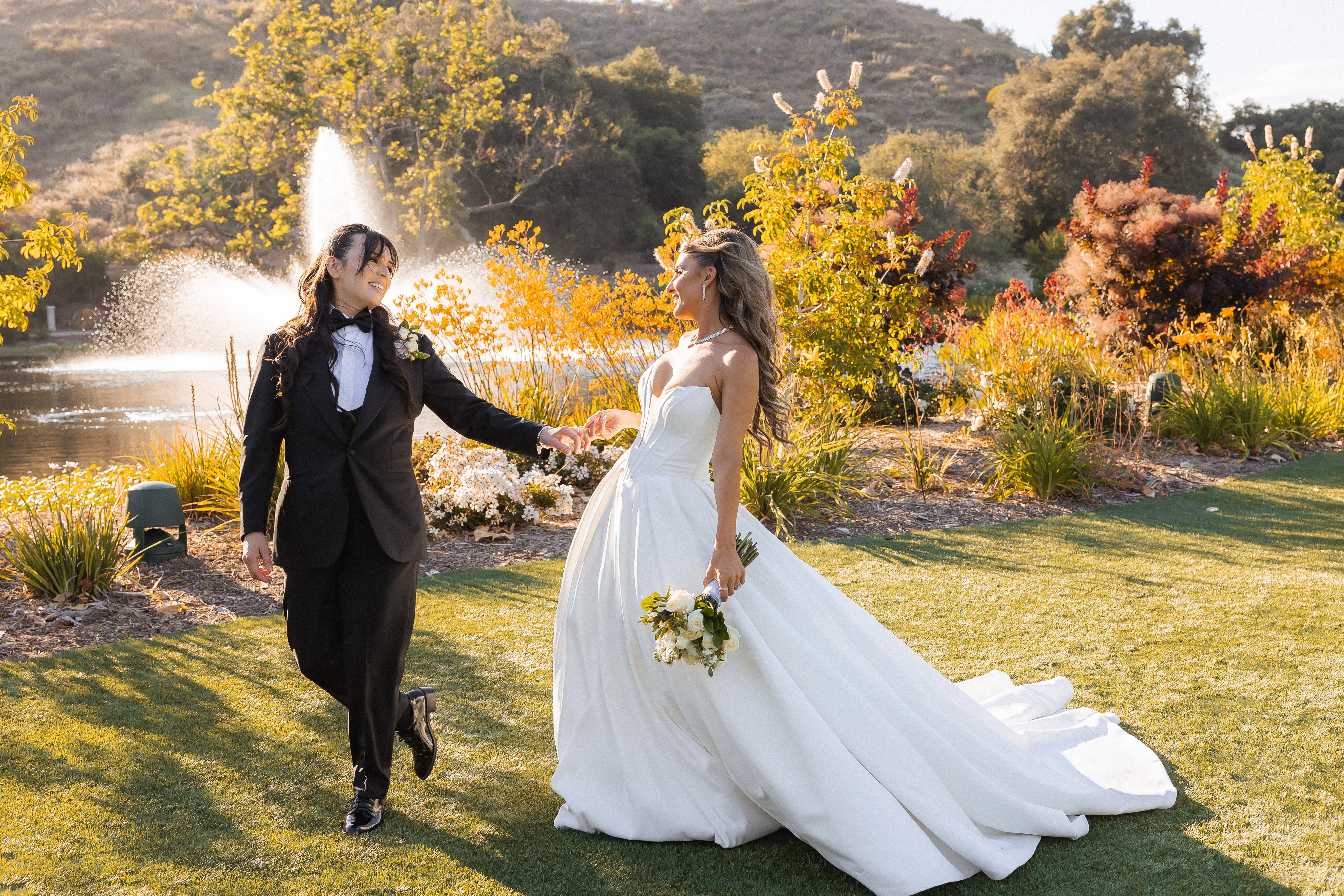 Bride wearing Derrick by Maggie Sottero walking with her partner