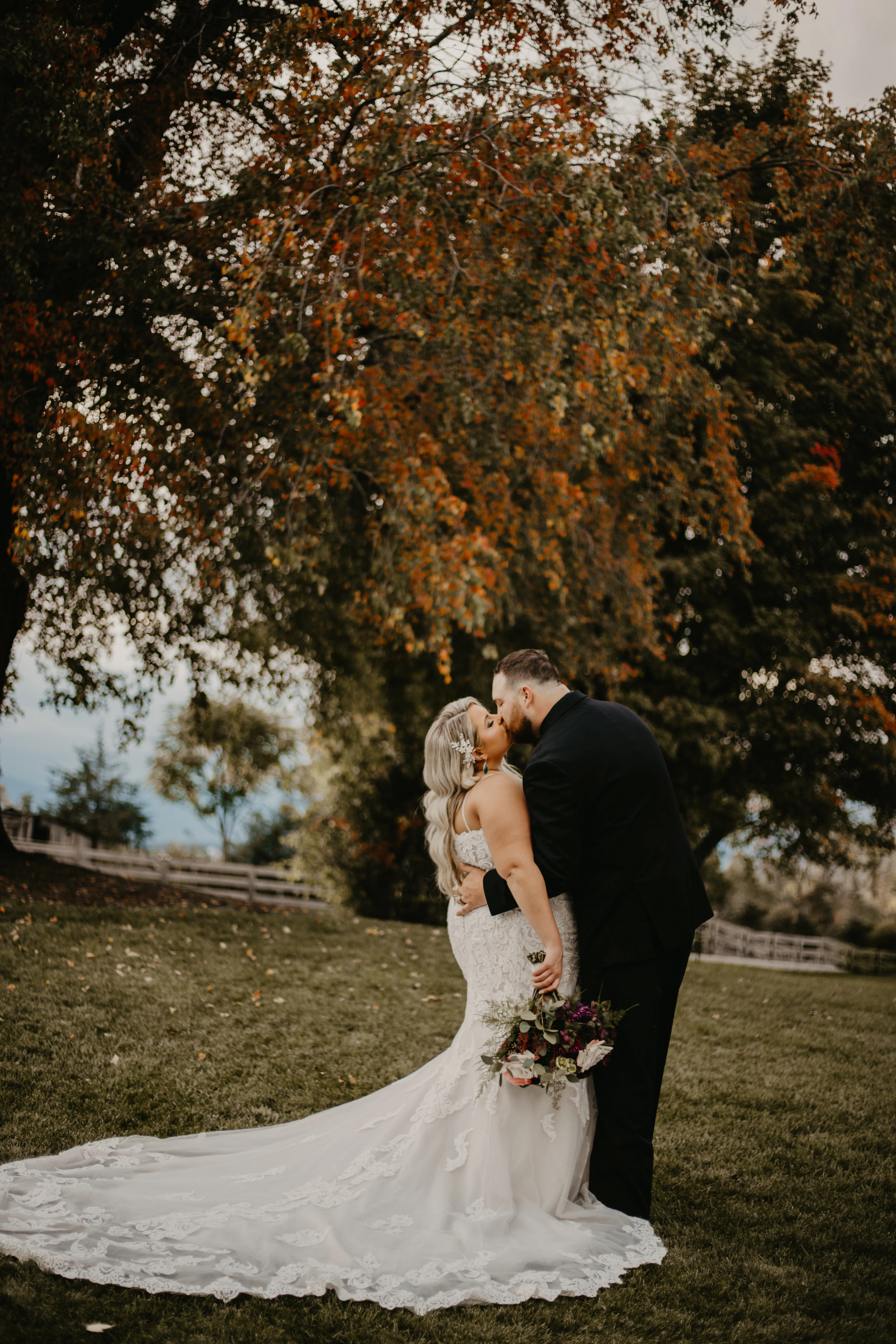 Bride wearing Fiona wedding gown by Maggie Sottero kissing her husband