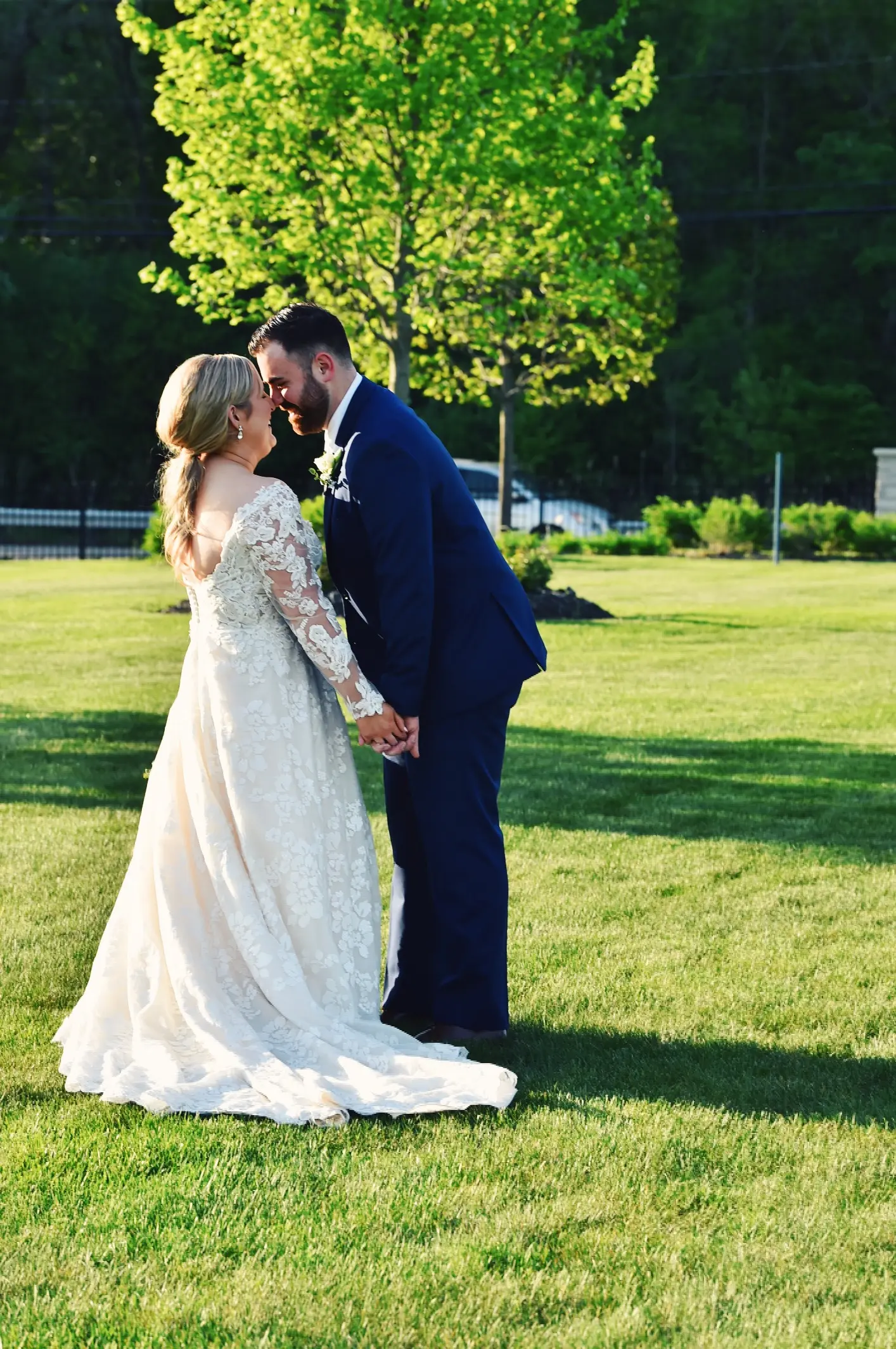 Bride Wearing Long Sleeve Floral Lace Wedding Dress Called Sawyer By Sottero and Midgley With Groom Touching Foreheads