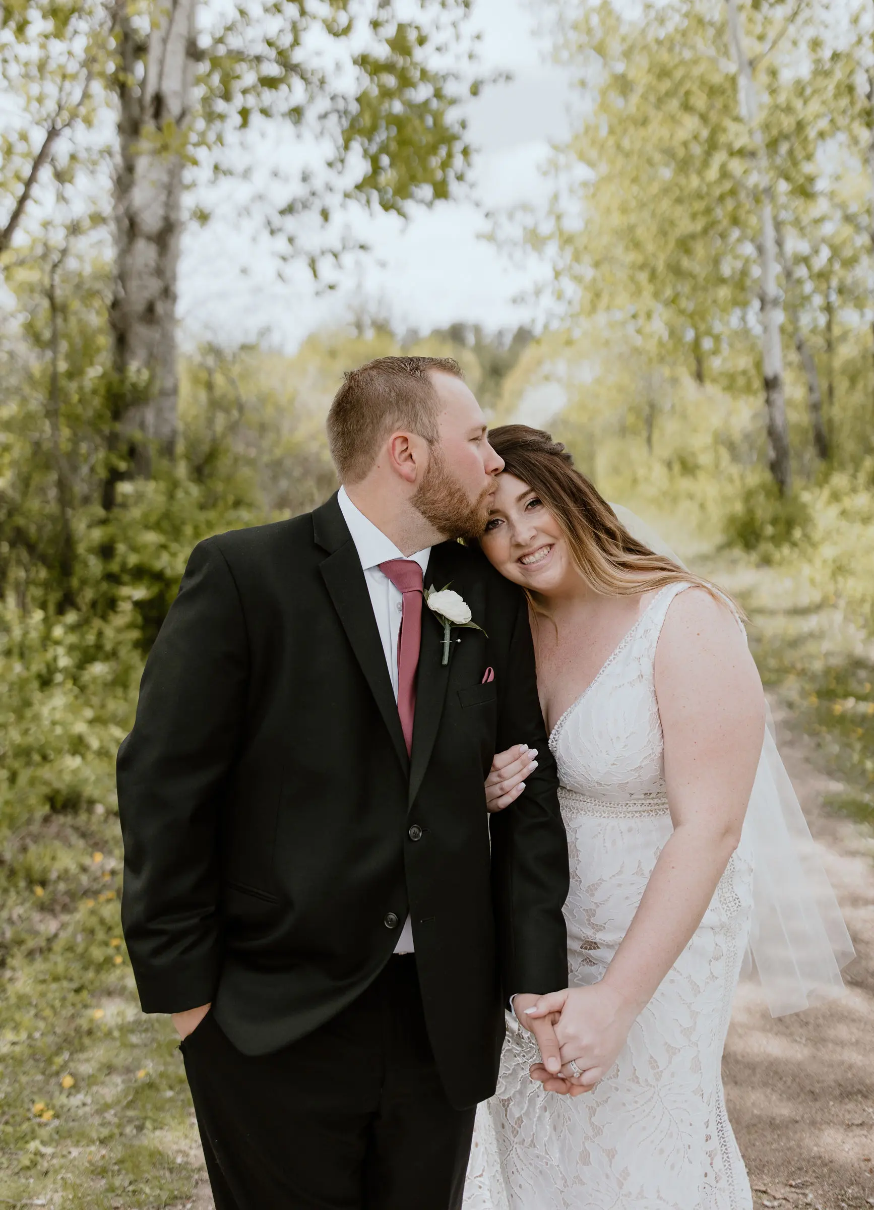 Groom Holding Hands with Bride in Boho Lace Wedding Dress with Oversized Florals Called Burke by Maggie Sottero