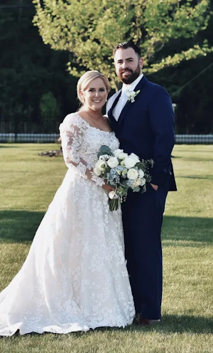 Bride Wearing Long Sleeve Floral Lace Wedding Dress Called Sawyer By Sottero and Midgley Holding Bouquet