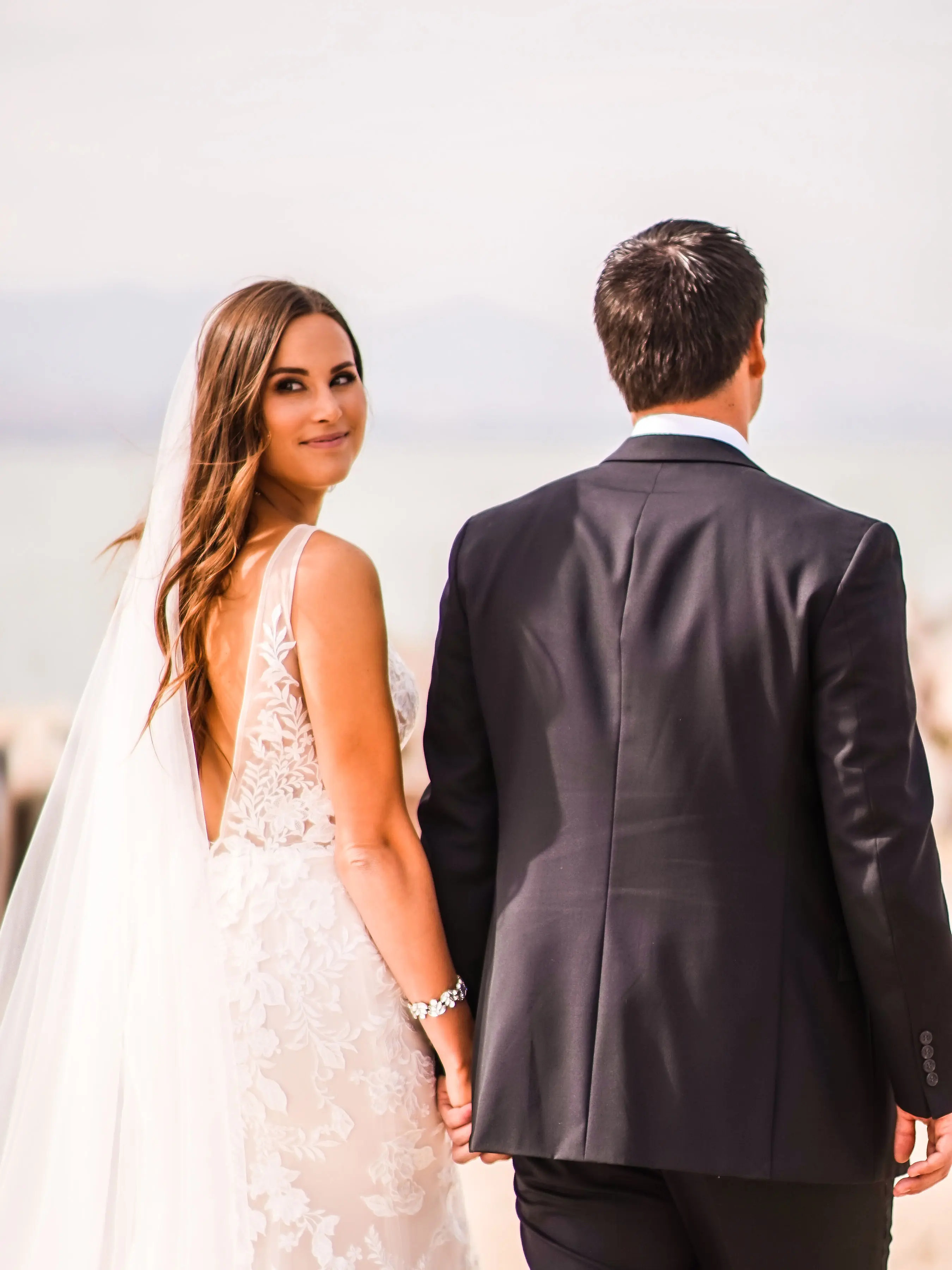 Groom with bride wearing sexy fit and flare wedding dress called Greenley by Maggie Sottero.
