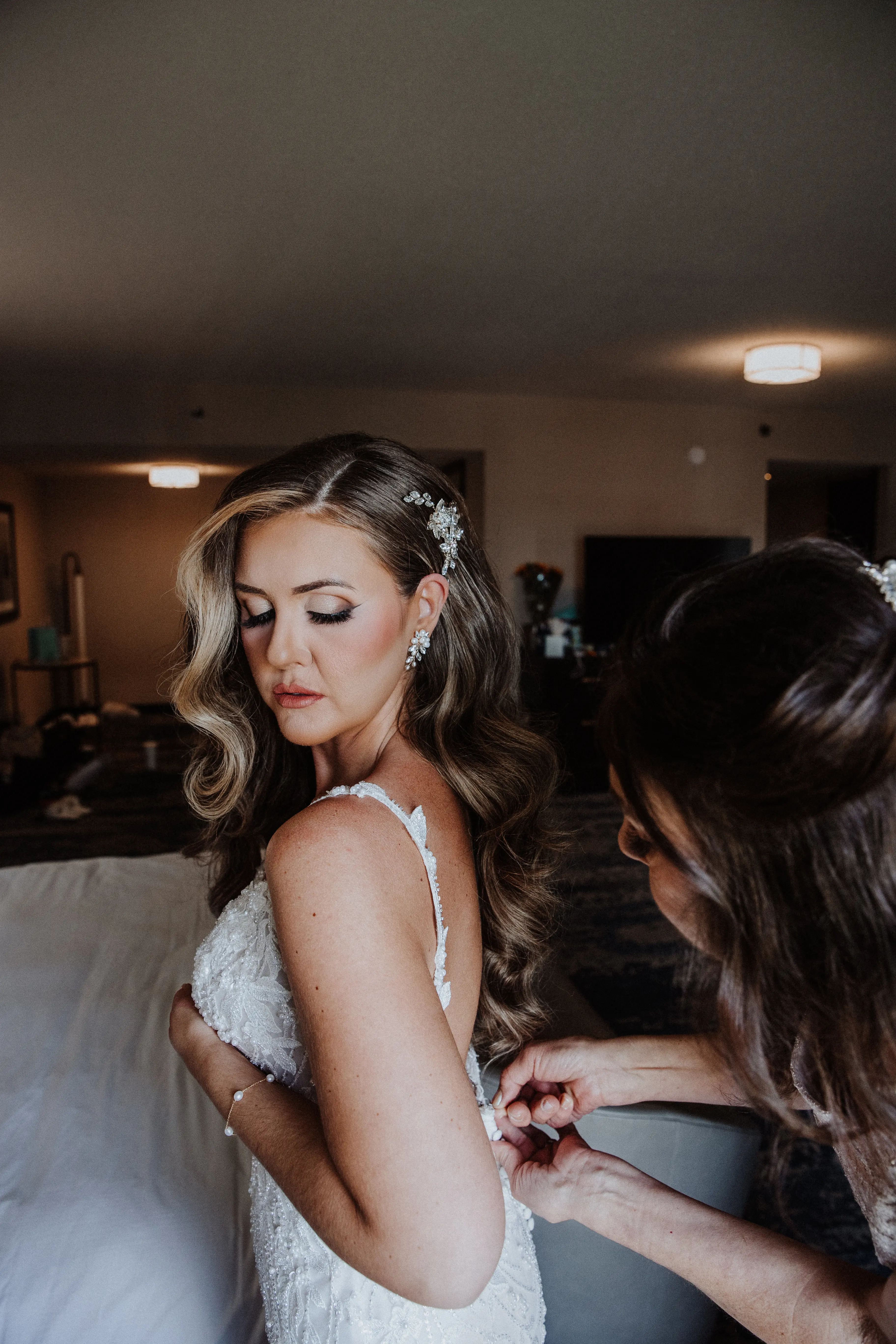 Bride Wearing Beaded Fit-n-flare Wedding Dress Called Jonah Lane By Sottero And Midgley Getting Dressed
