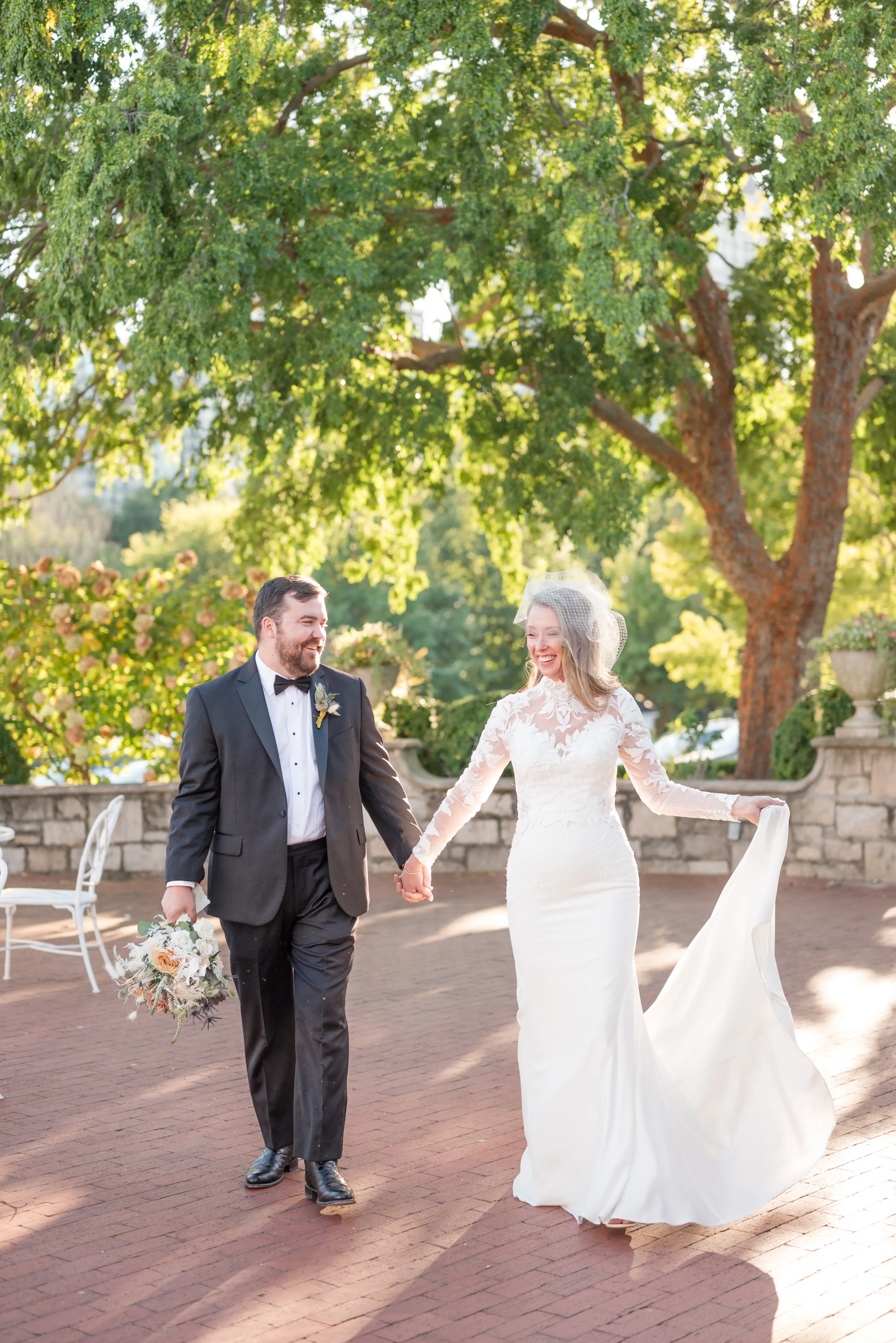 Bride wearing Dionne wedding dress by Rebecca Ingram walking with her husband