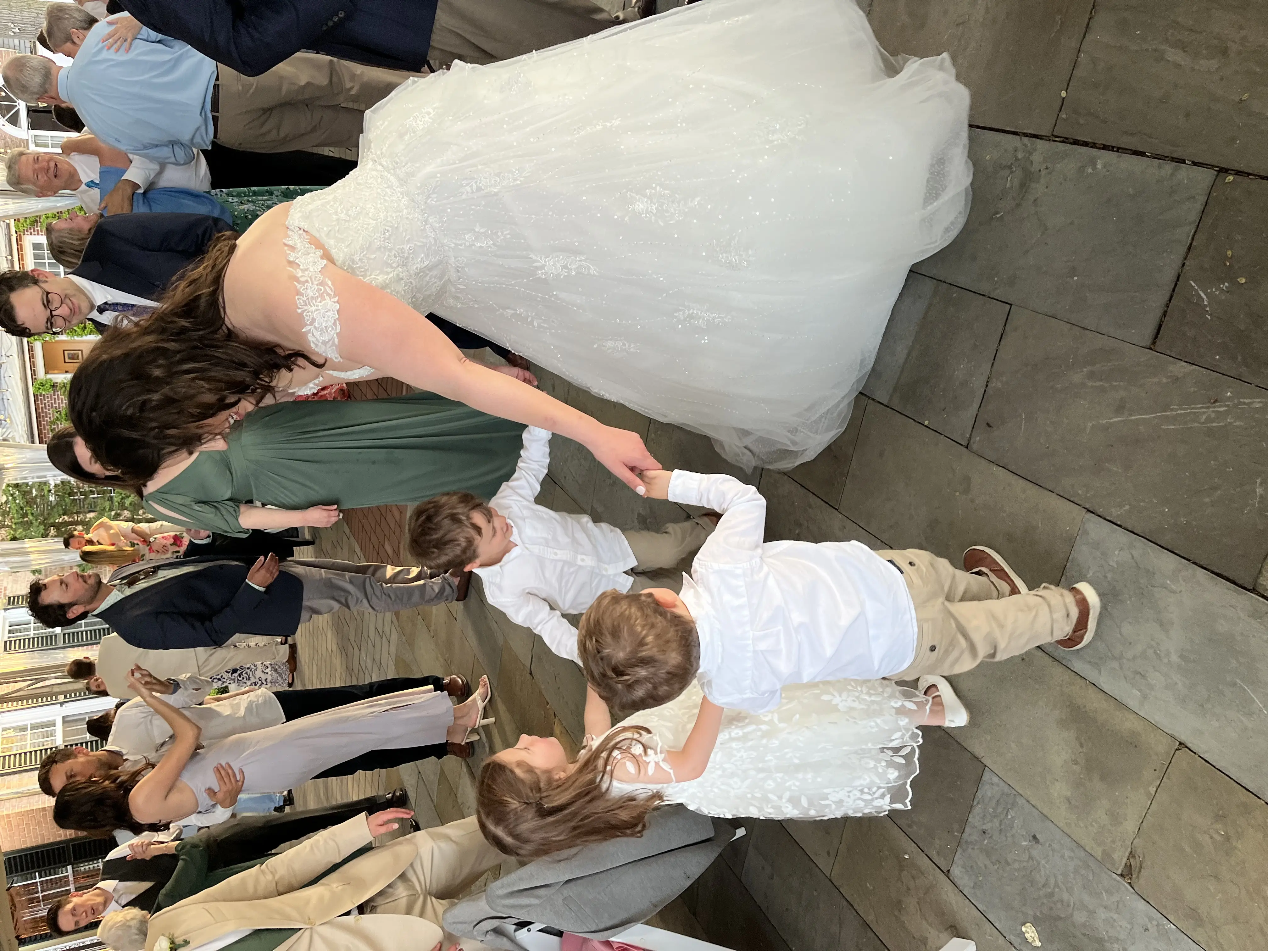 Bride wearing Mason by Sottero and Midgley dancing with kids