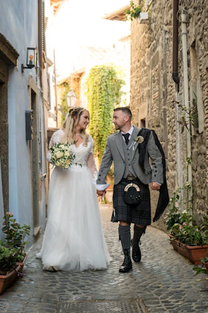 Bride wearing Iris wedding dress by Rebecca Ingram with her husband