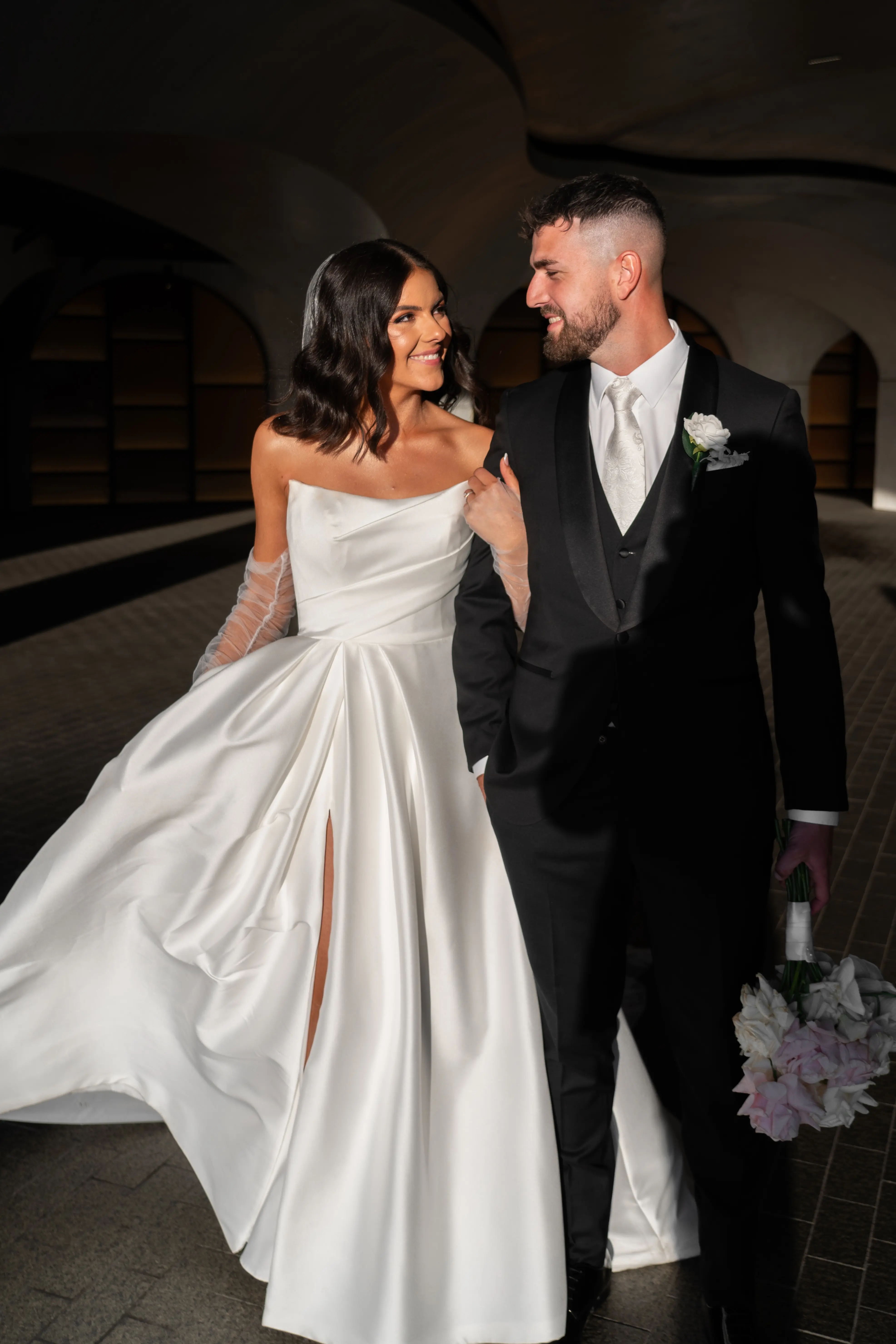 Bride wearing Aspen by Sottero and Midgley walking with her husband