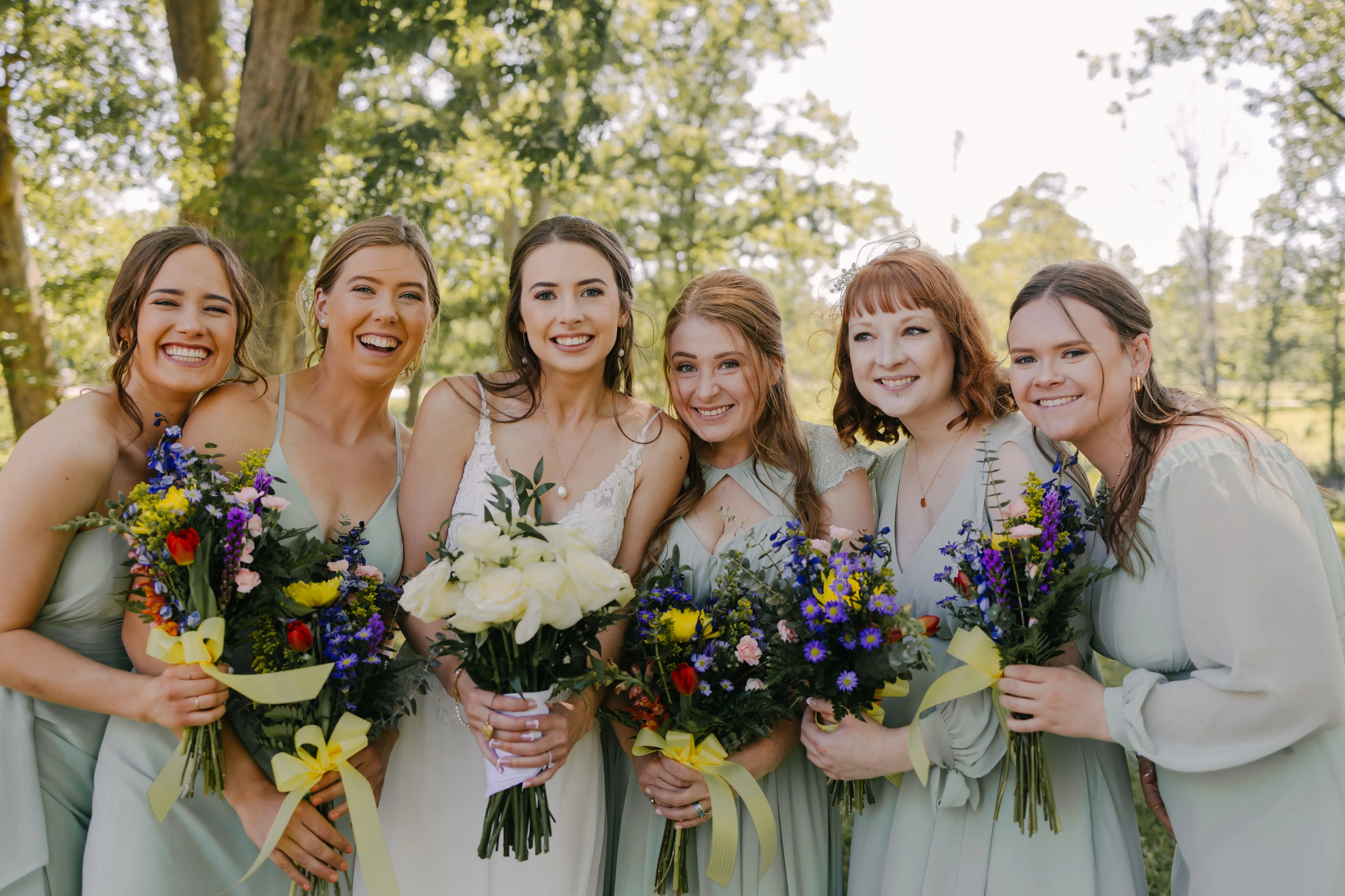 Bride wearing Charlotte by Rebecca Ingram with her bridesmaids