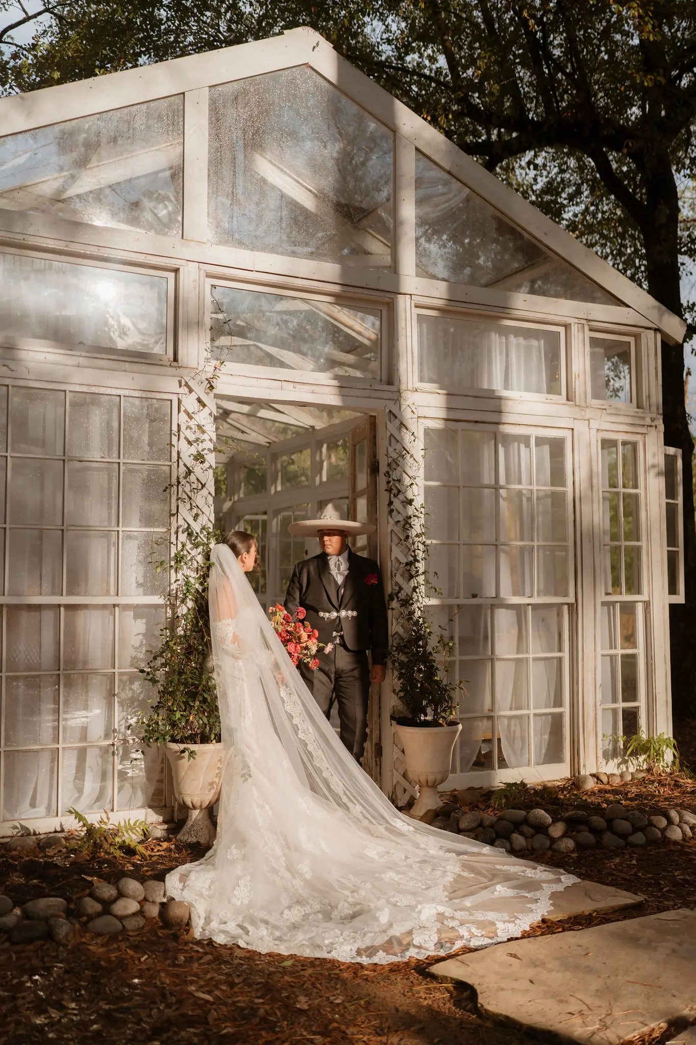 Bride wearing Fiona wedding dress by Maggie Sottero coming out of a greenhouse