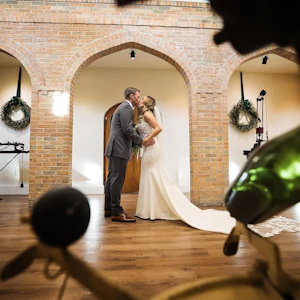 Bride Wearing Lace Mermaid Wedding Gown Called Nikki By Maggie Sottero Kissing The Groom