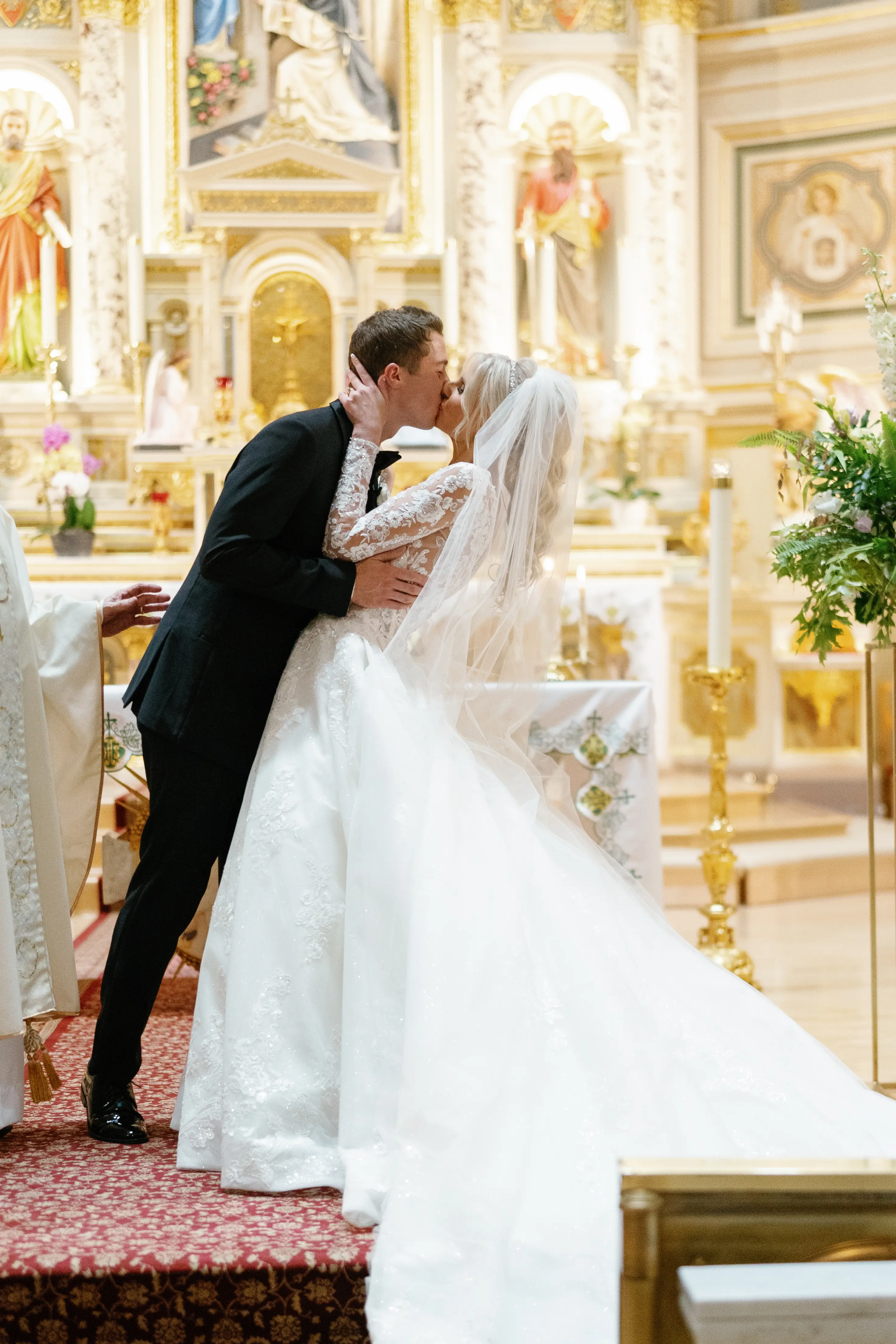 Bride Wearing Lace Princess Wedding Dress Called Norvinia By Sottero And Midgley Kissing Groom In A Chapel