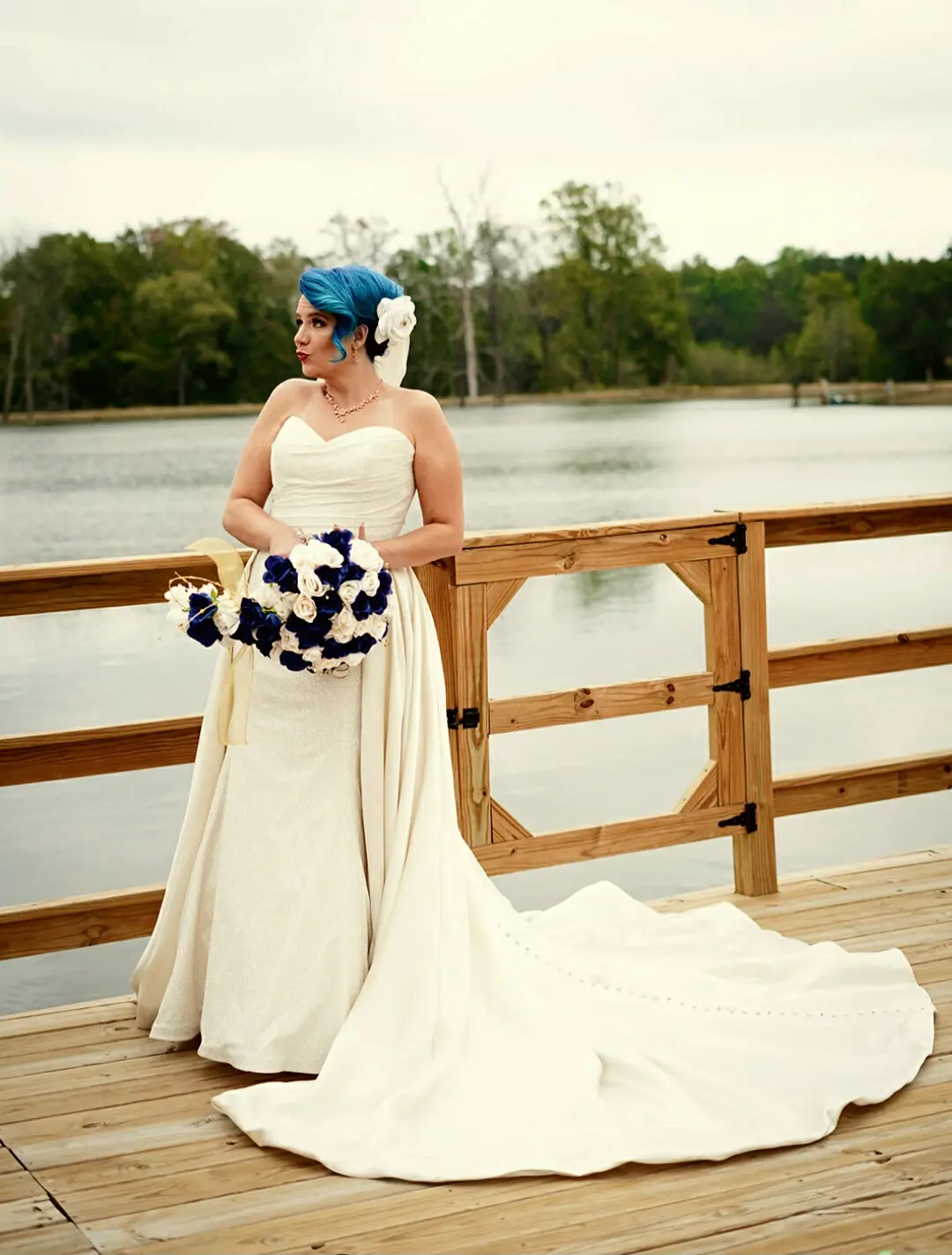 Bride Wearing Sparkly Fit-and-Flare Wedding Dress With White and Blue Bouquet