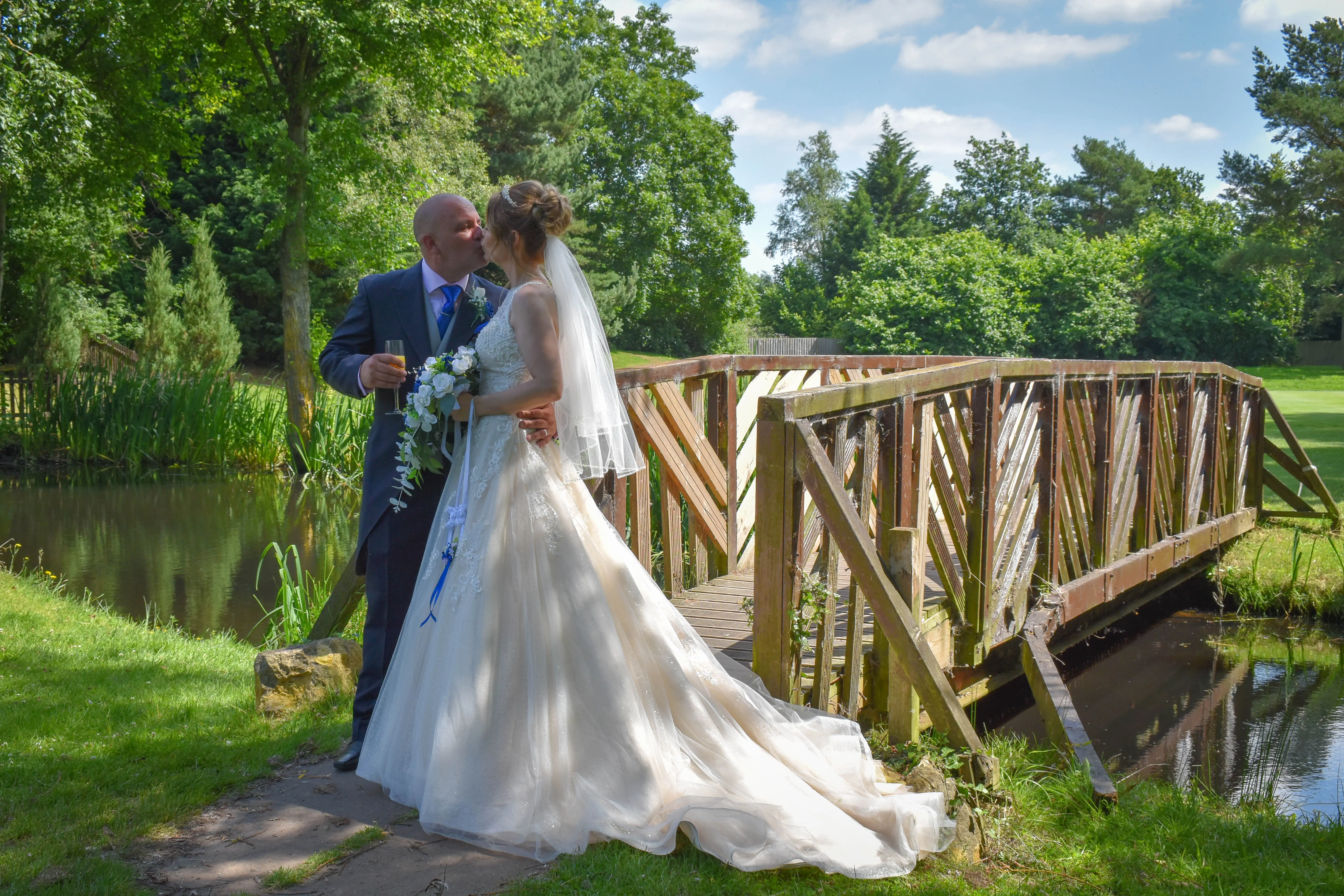 Bride with groom wearing a lace and tulle ballgown wedding dress