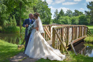 Bride with groom wearing a lace and tulle ballgown wedding dress