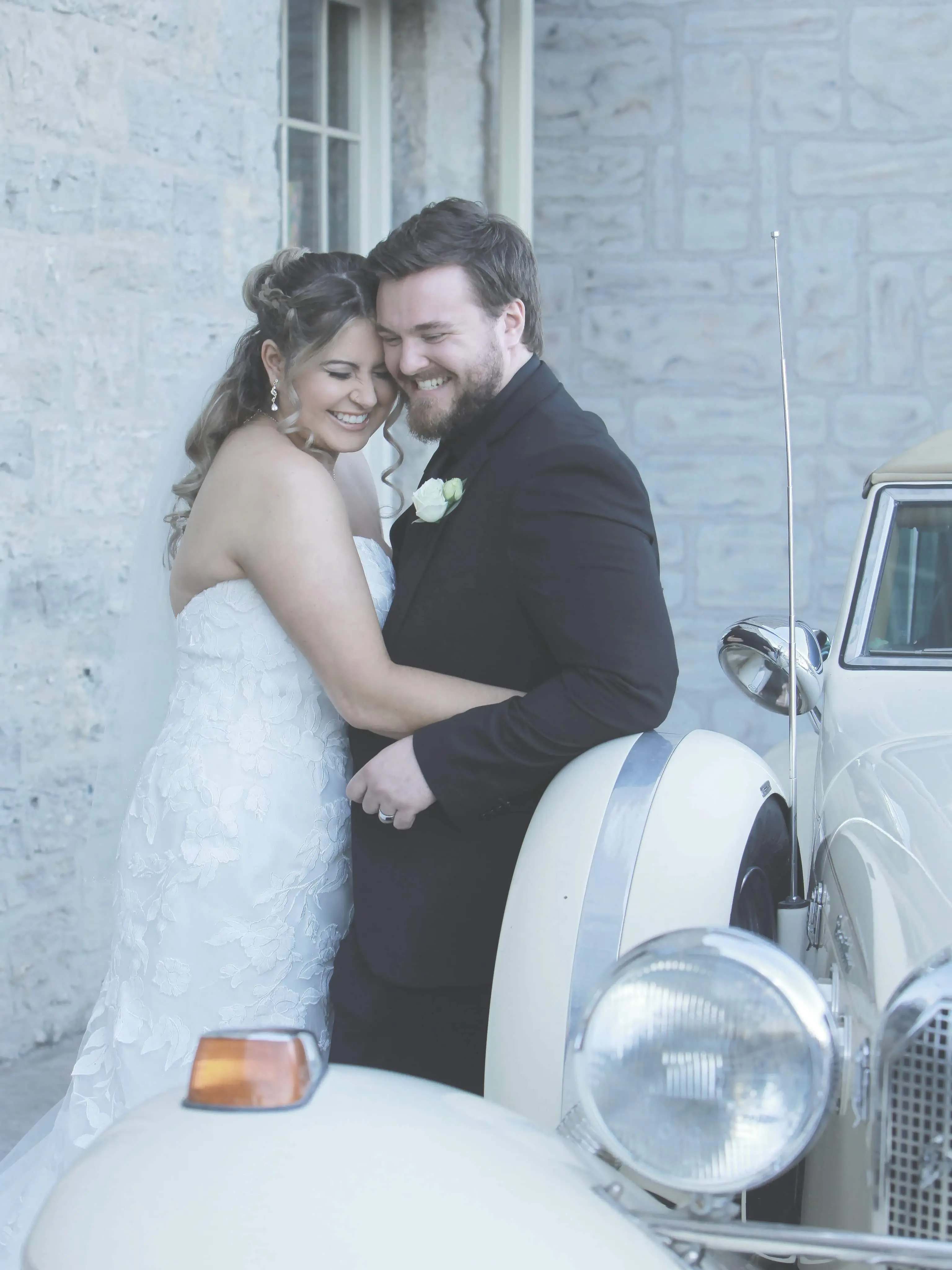 Groom with Real Bride in Strapless Mermaid Bridal Gown with Oversize Floral Lace Motifs Called Hattie by Rebecca Ingram