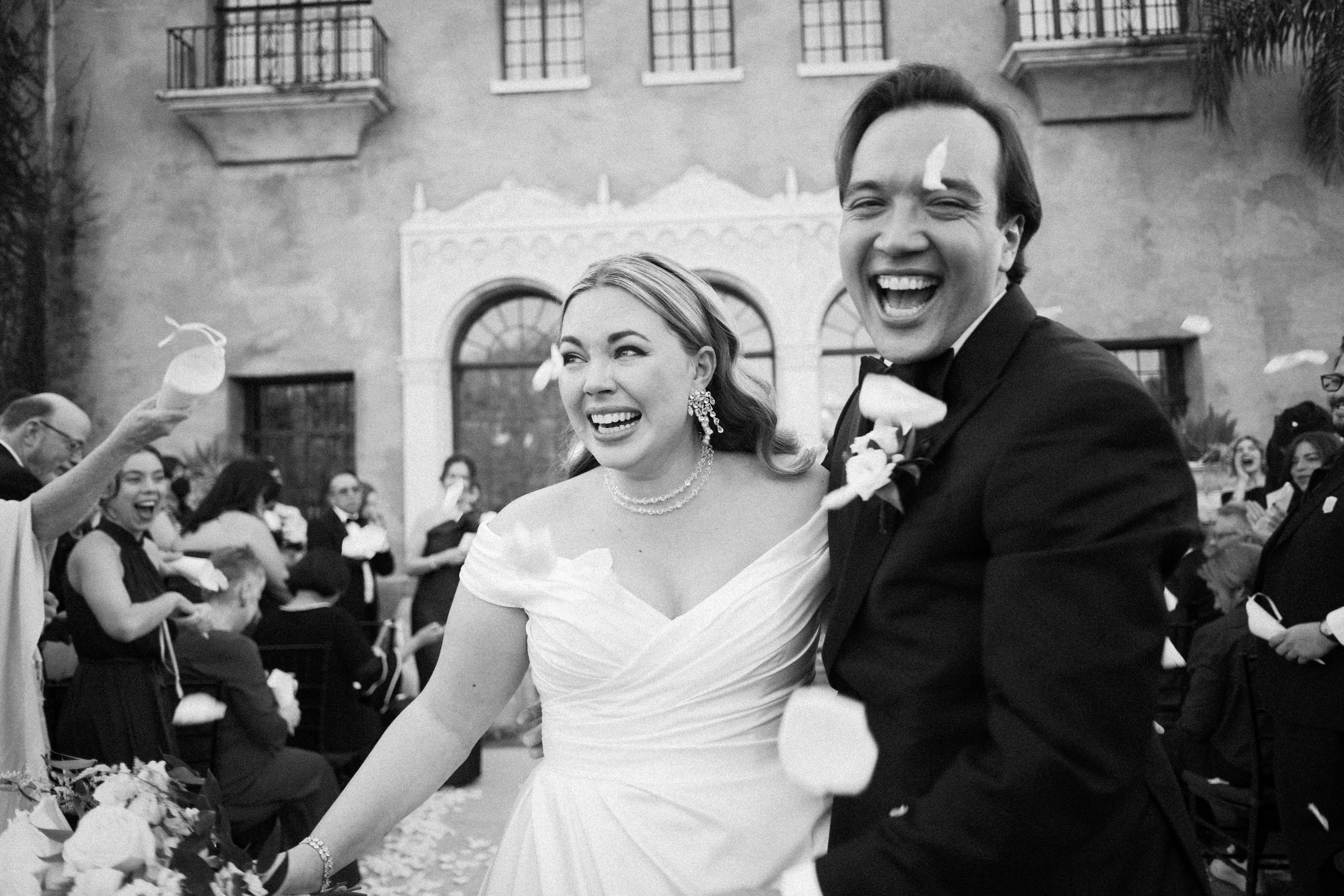 Bride wearing Ekaterina by Maggie Sottero laughing with her husband