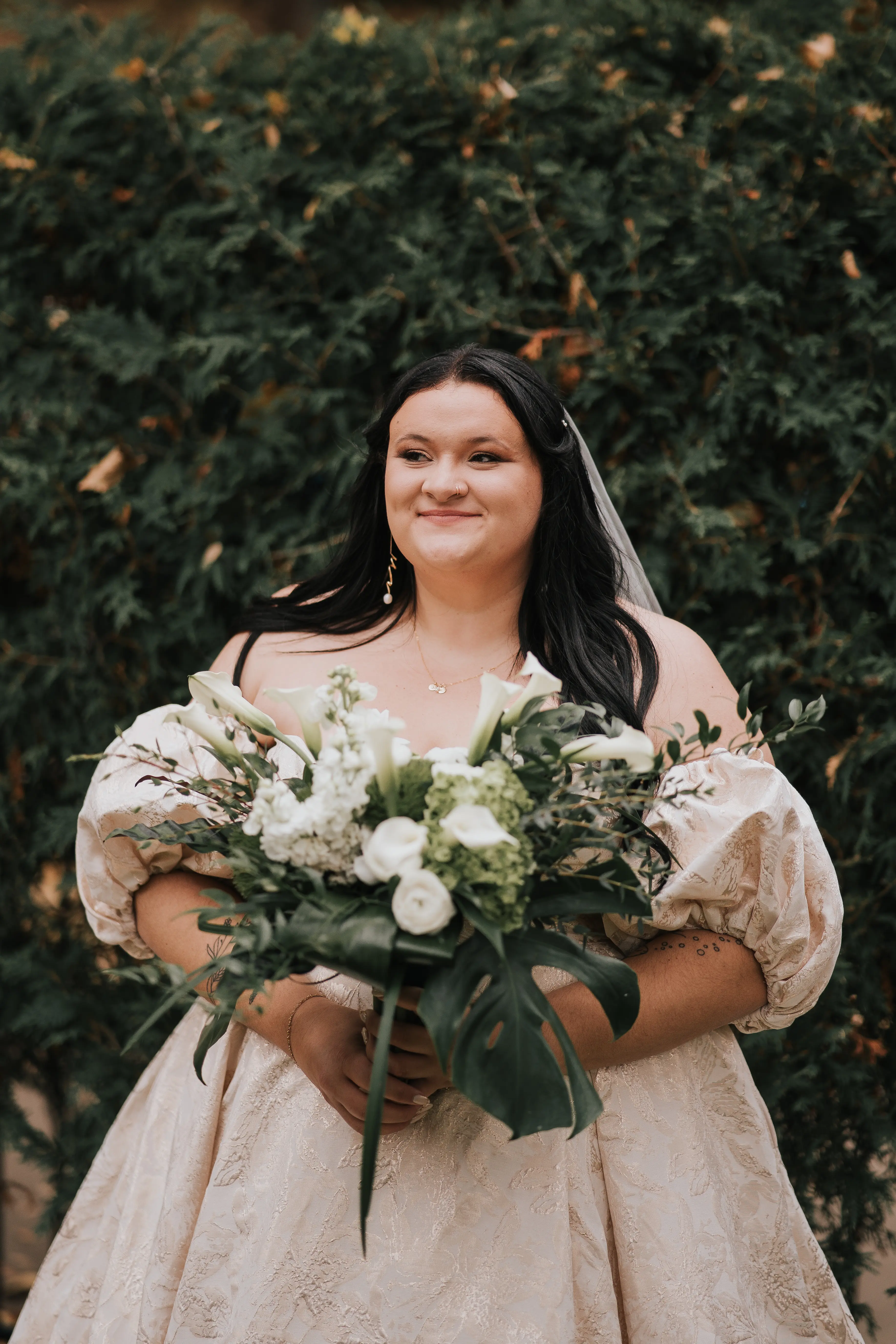 Bride Wearing Floral Jacquard Princess Wedding Gown Called Cyprus By Sottero And Midgley Holding White Floral And Leafy Bouquet