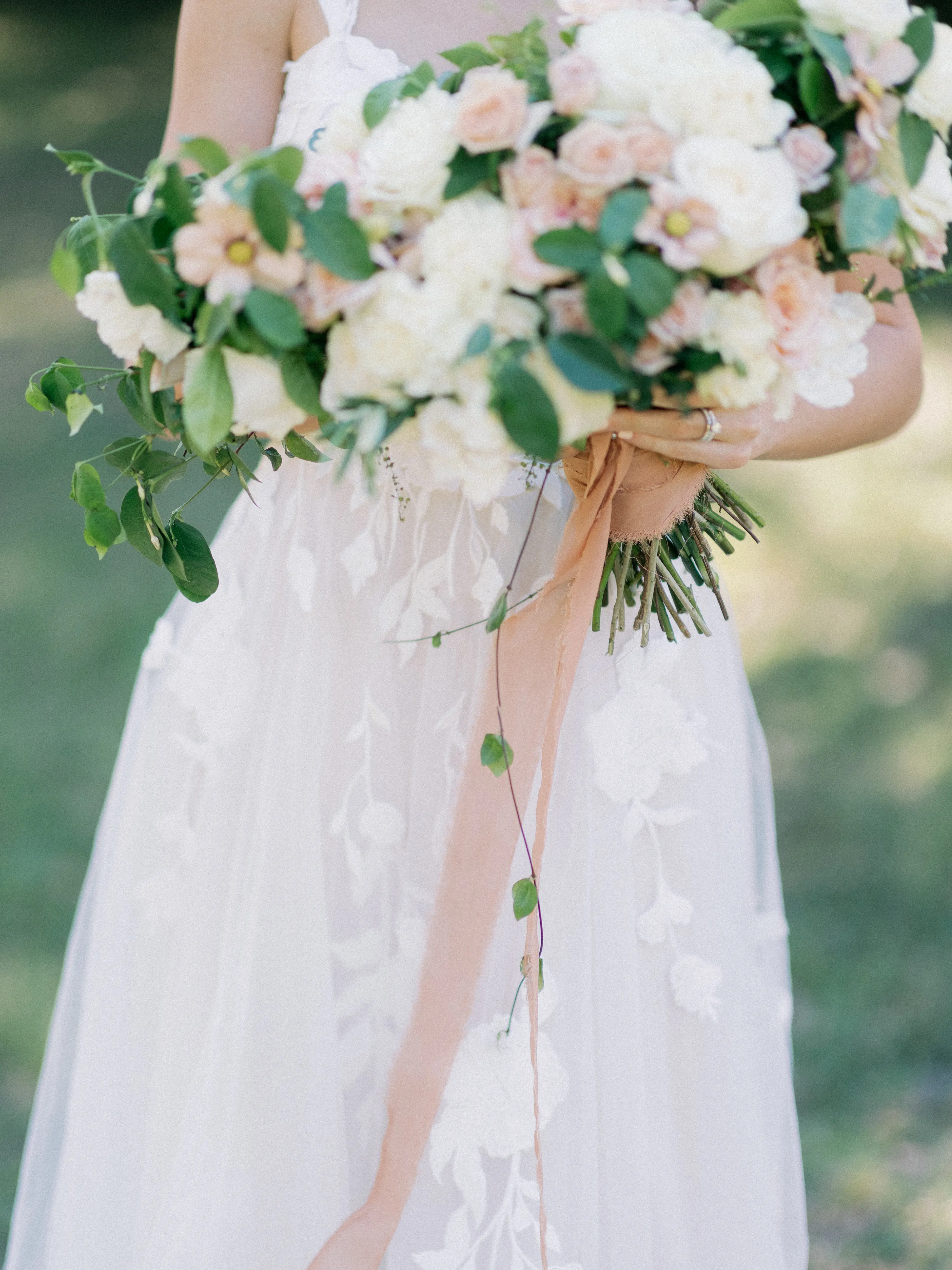 Bride Wearing Plunging V-Neckline Bridal Dress Named Hattie Lane Marie By Rebecca Ingram Bride Holding Flower Bouquet