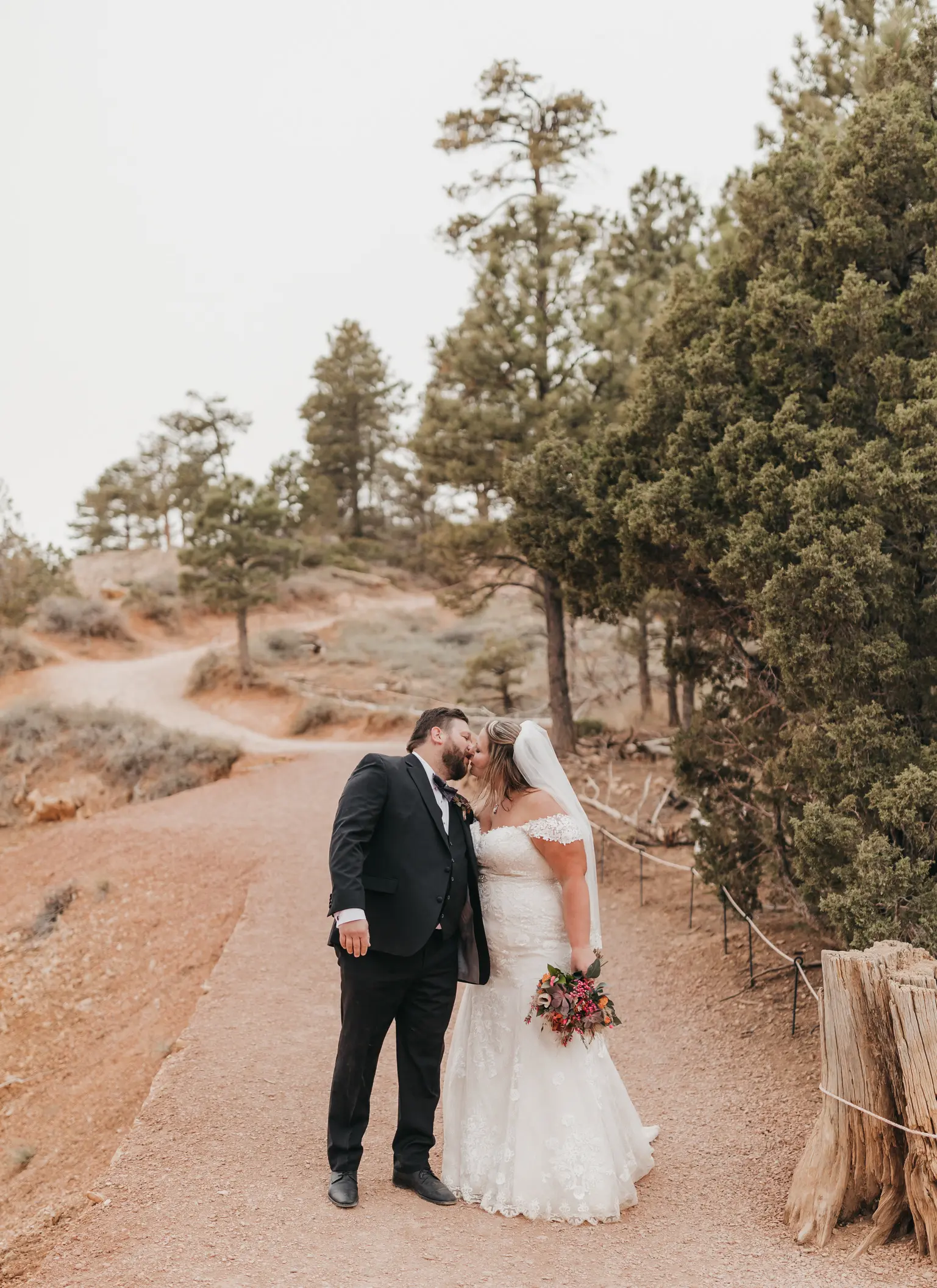 bride with groom in corset back fit and flare wedding dress