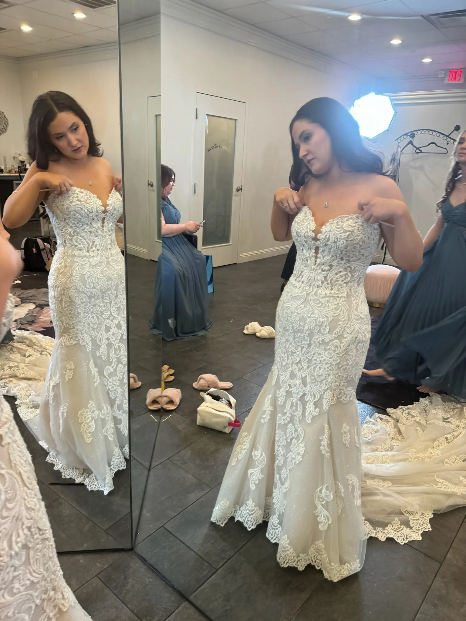 Bride Wearing Fit-n-Flare Wedding Dress Called Fiona By Maggie Sottero Trying On At A Bridal Shop