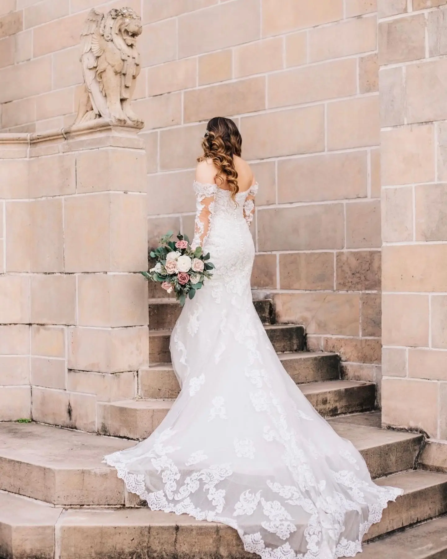 Bride Wearing Lace Sheath Wedding Dress Called Fiona By Maggie Sottero Holding White And Pink Flower Bouquet