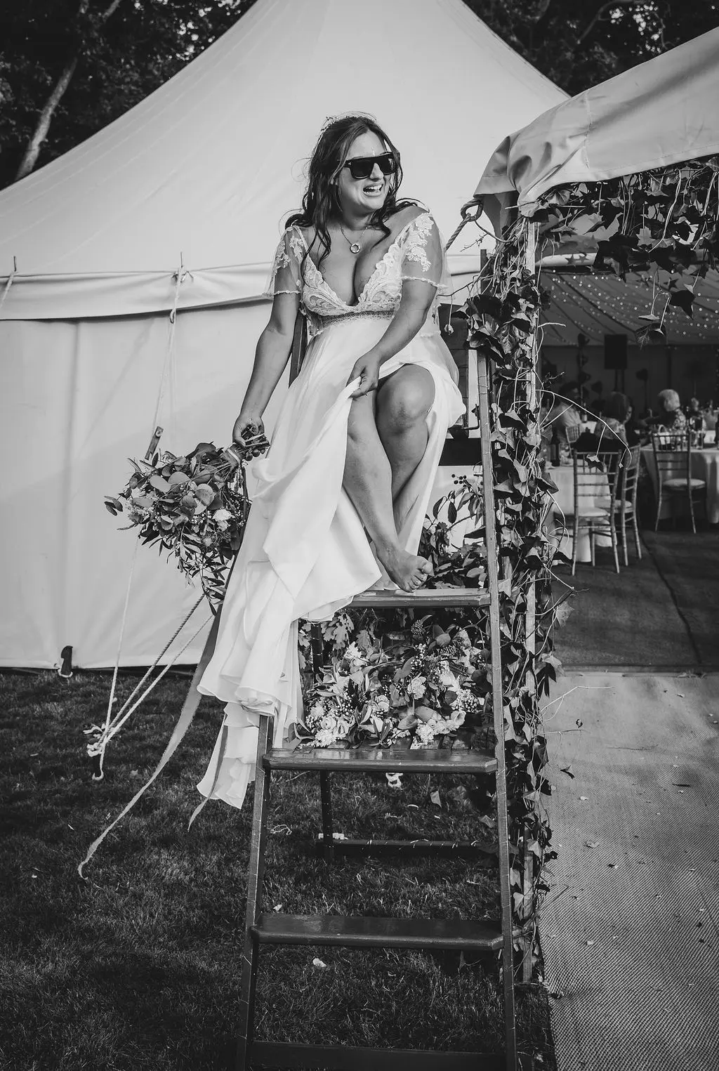 Bride wearing Lorraine by Rebecca Ingram sitting on a ladder