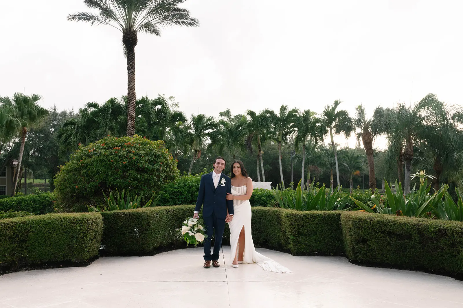 Bride Wearing Grecian Inspired Wedding Dress Called Gabrielle By Maggie Sottero In A Garden With Groom