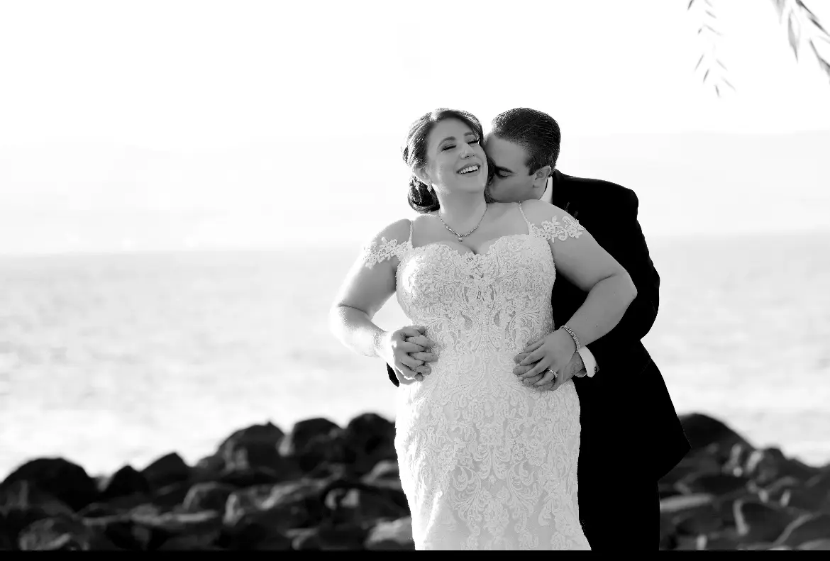 Bride wearing Fiona wedding dress by Maggie Sottero cuddling with her husband