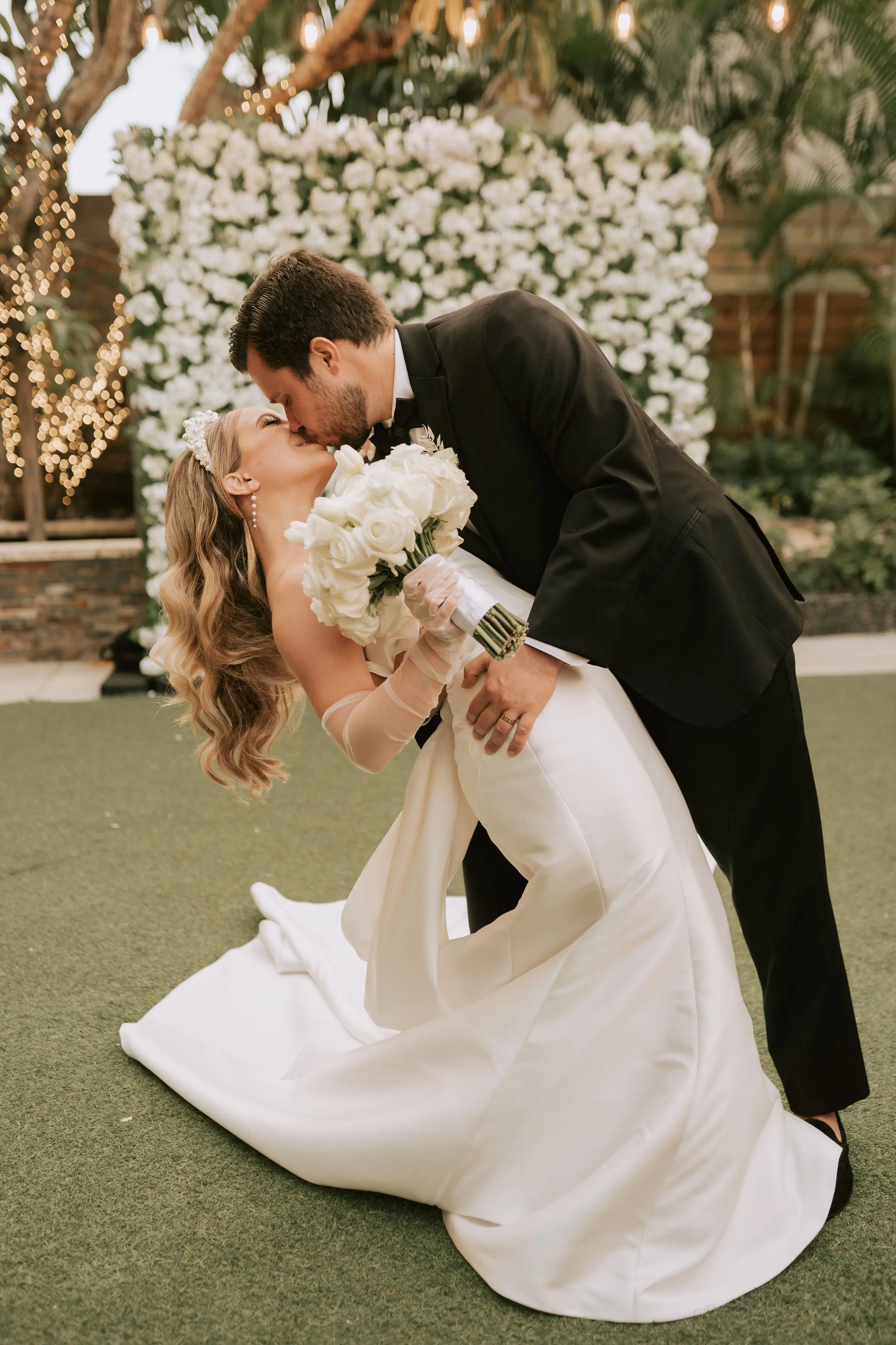 Groom With Bride Wearing Simple Sheath Satin Dress With Back Bow Mitchell By Maggie Sottero