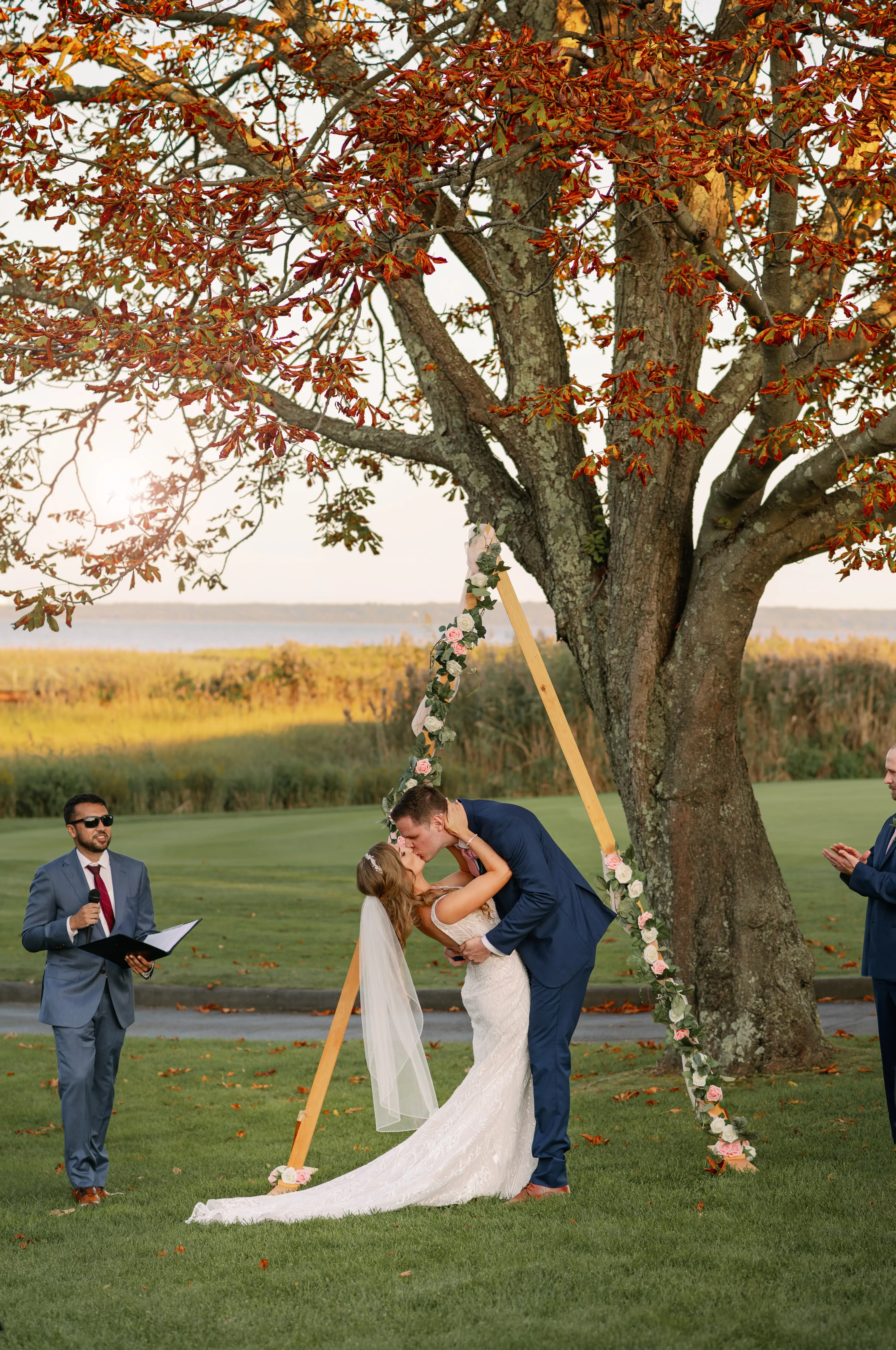 Groom dipping his bride for their first wedded kiss.