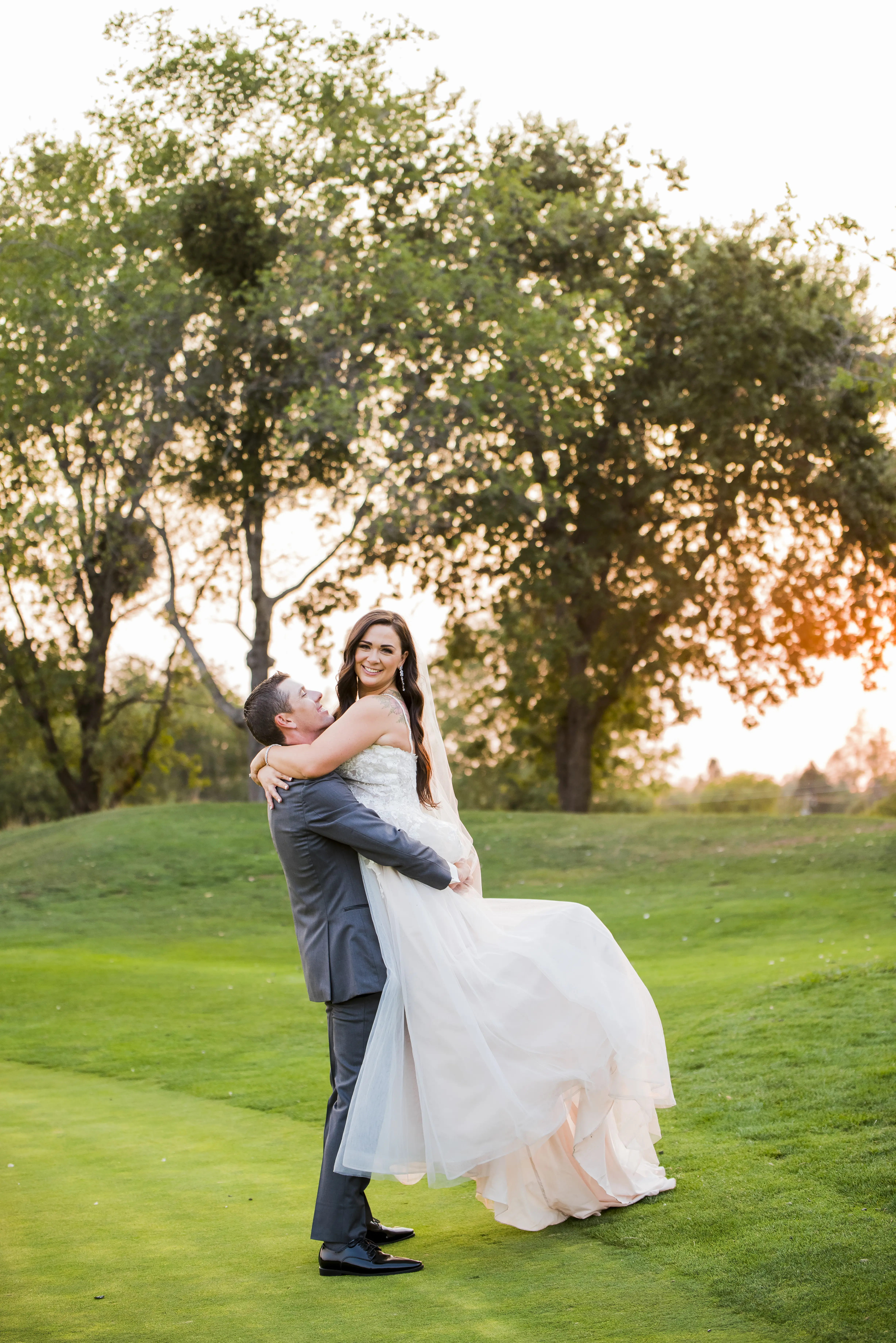 Bride wearing Princess Wedding Gown called Stevie by Maggie Sottero being picked up by the groom