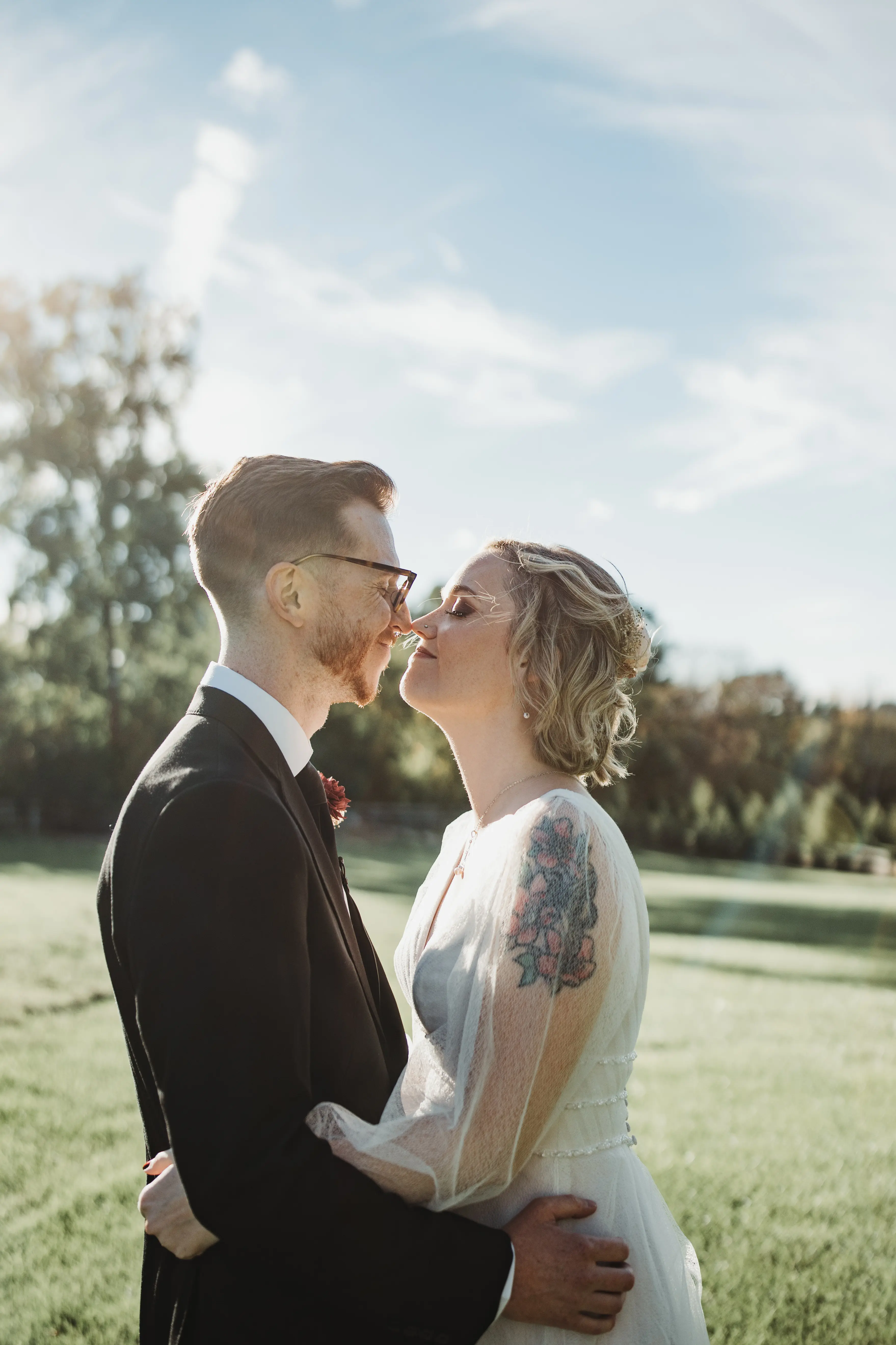 Bride Wearing Long-Sleeve A-Line Wedding Dress Called Joanne By Rebecca Ingram Holding Groom