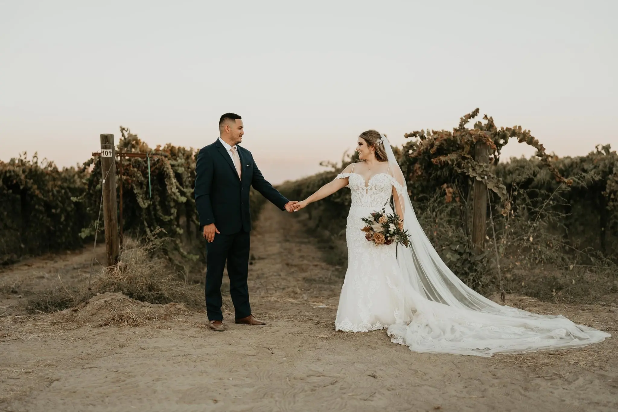 Groom Holding Hands With Bride In Lacey Fit And Flare Wedding Dress Named Fiona By Maggie Sottero