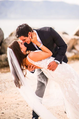 Groom with bride wearing sexy fit and flare wedding dress called Greenley by Maggie Sottero.