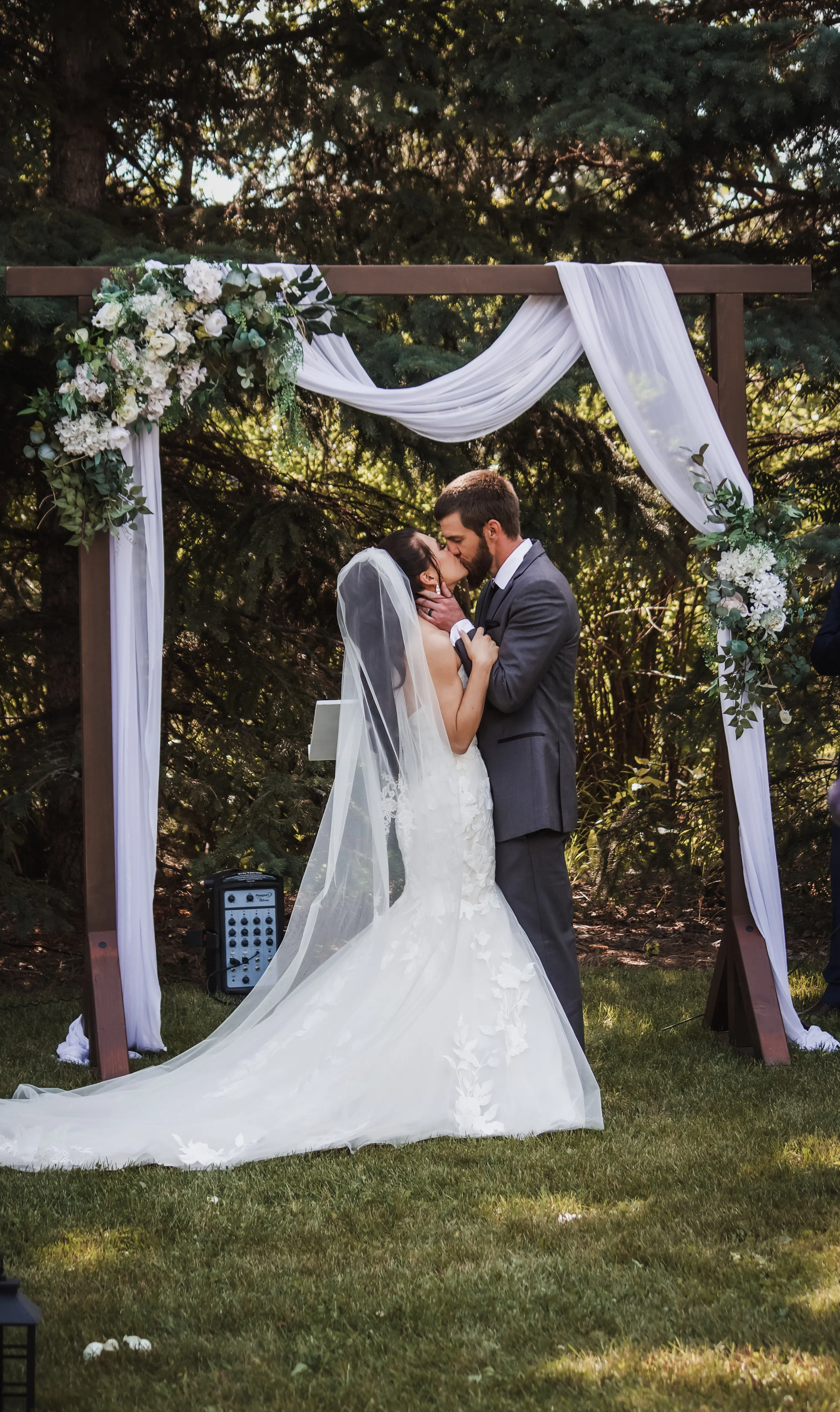 Bride Wearing Lace Mermaid Wedding Dress Called Hattie By Rebecca Ingram Kissing Groom