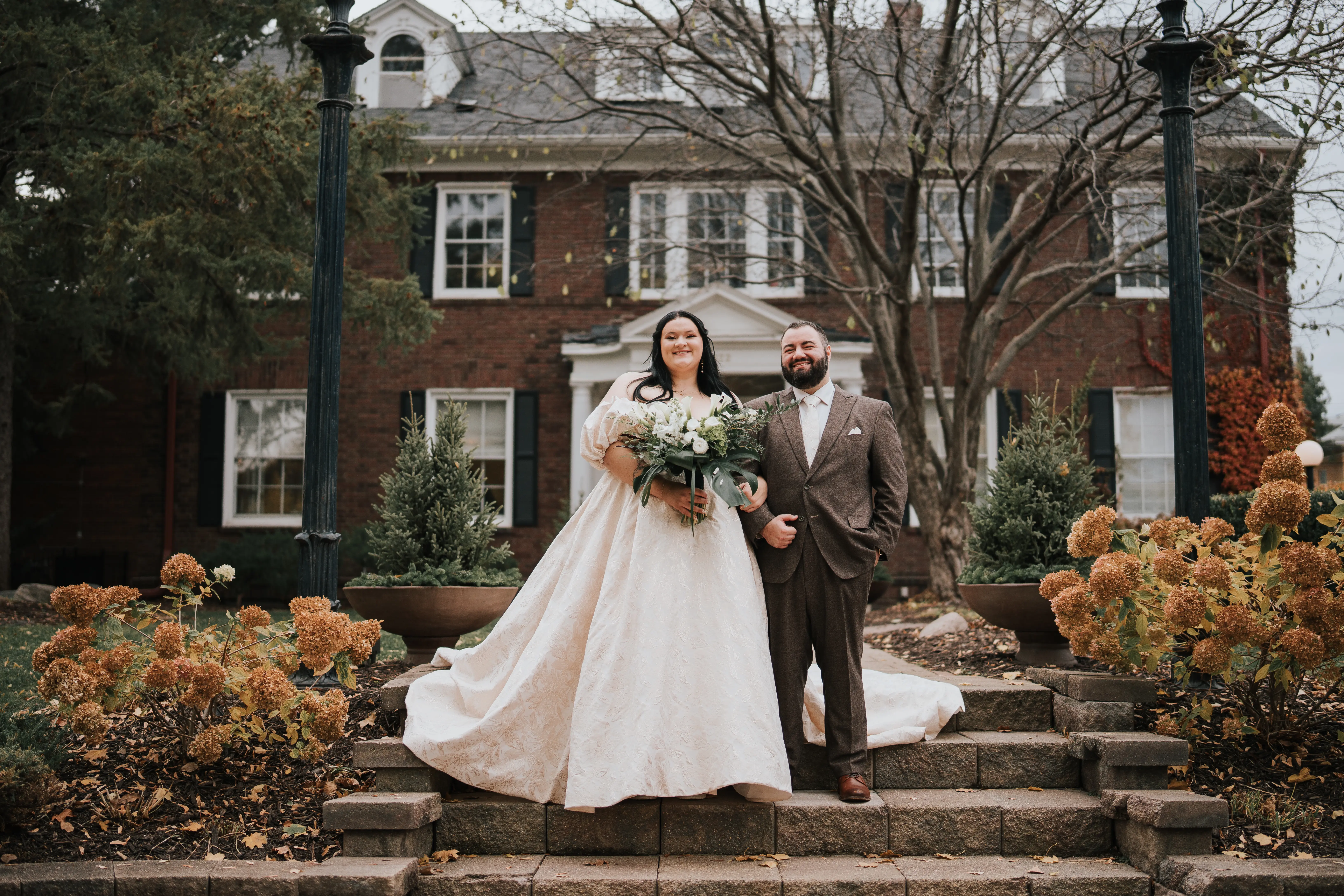 Bride Wearing Floral Jacquard Princess Wedding Gown Called Cyprus By Sottero And Midgley With Groom On A Staircase