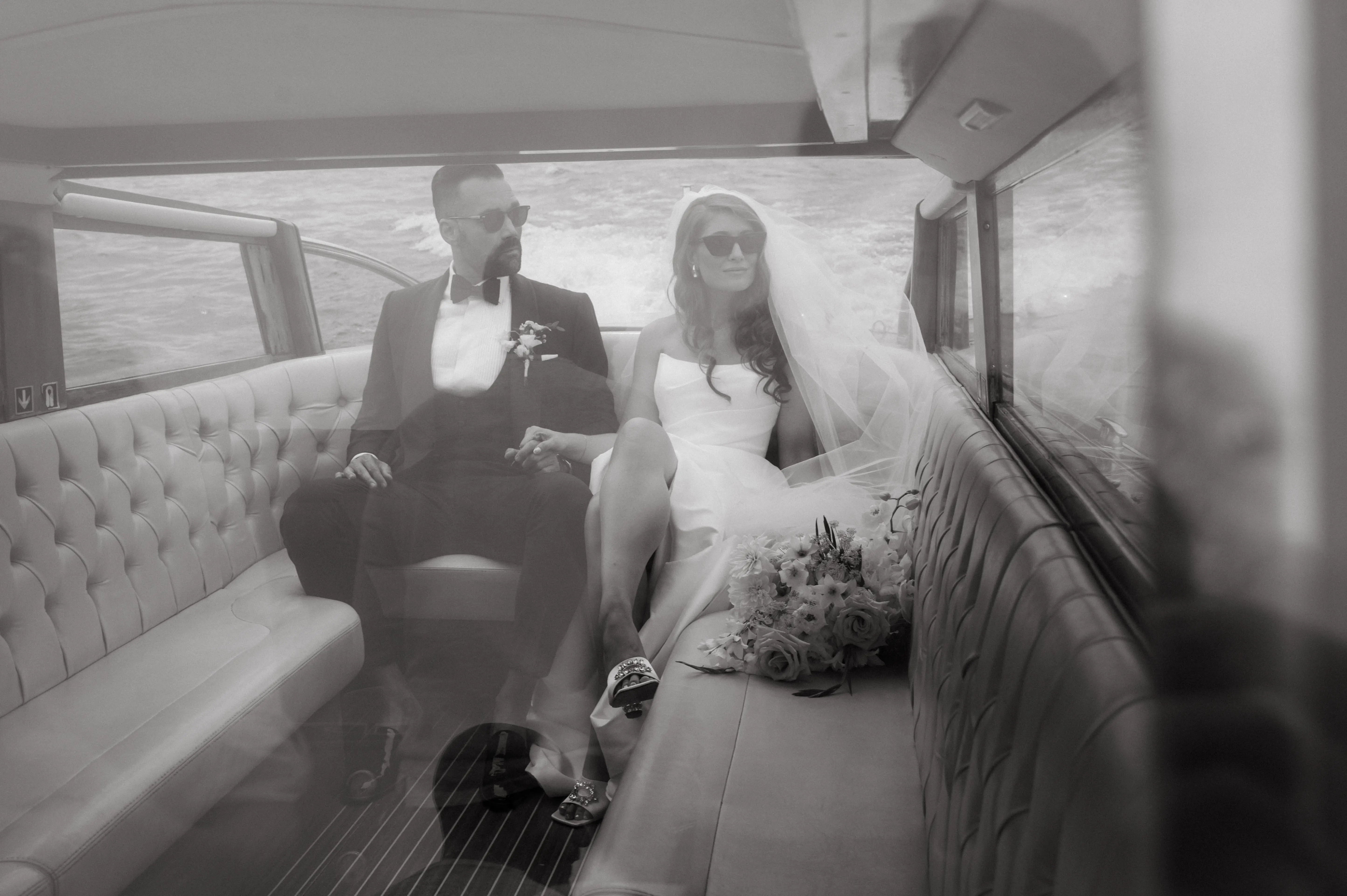 Bride wearing Aspen by Sottero and Midgley on the back of a boat with her husband