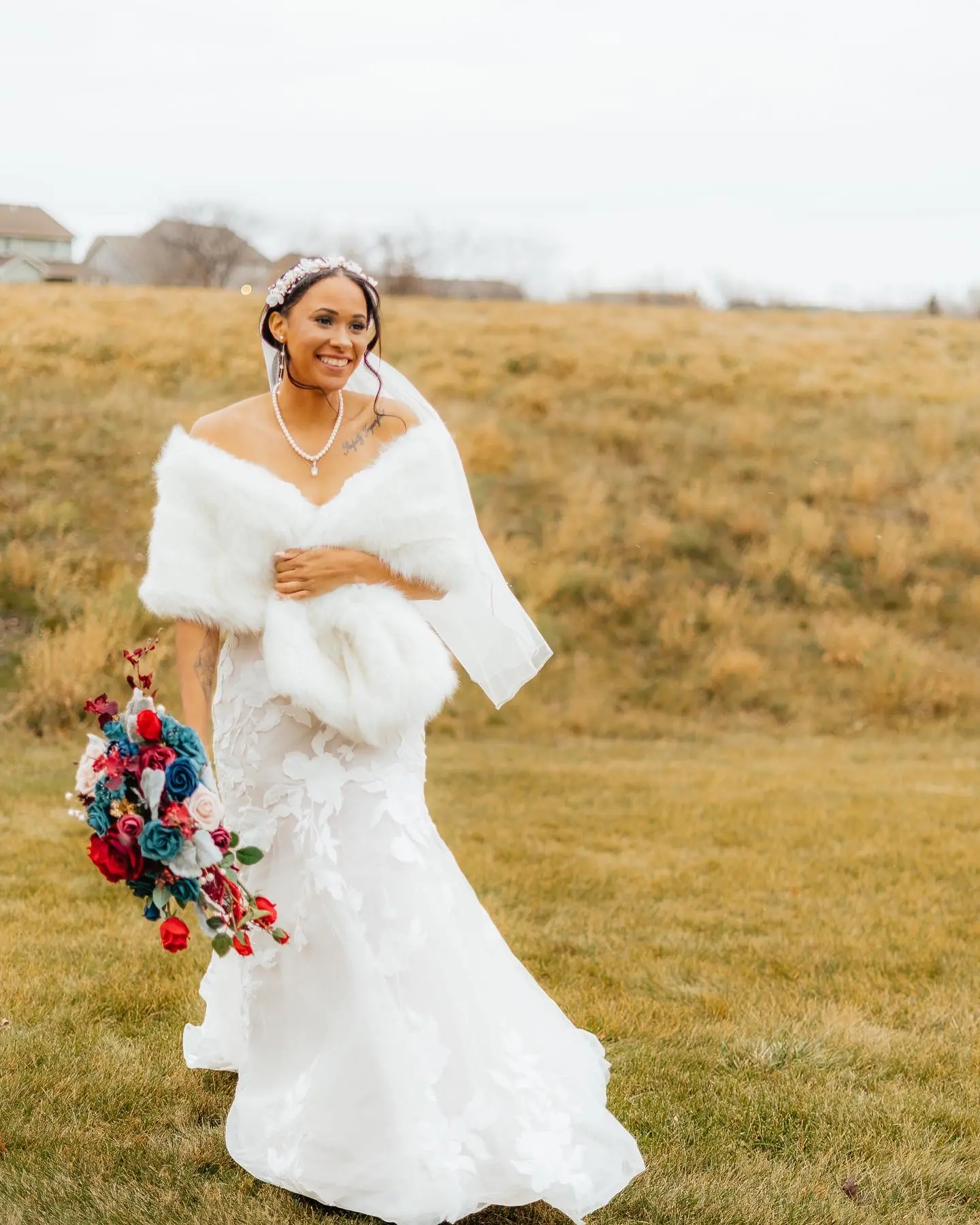 Black Bride In Sexy Mermaid Wedding Dress Called Hattie By Rebecca Ingram With Fur Wrap, Bridal Veil, And Colorful Flowers