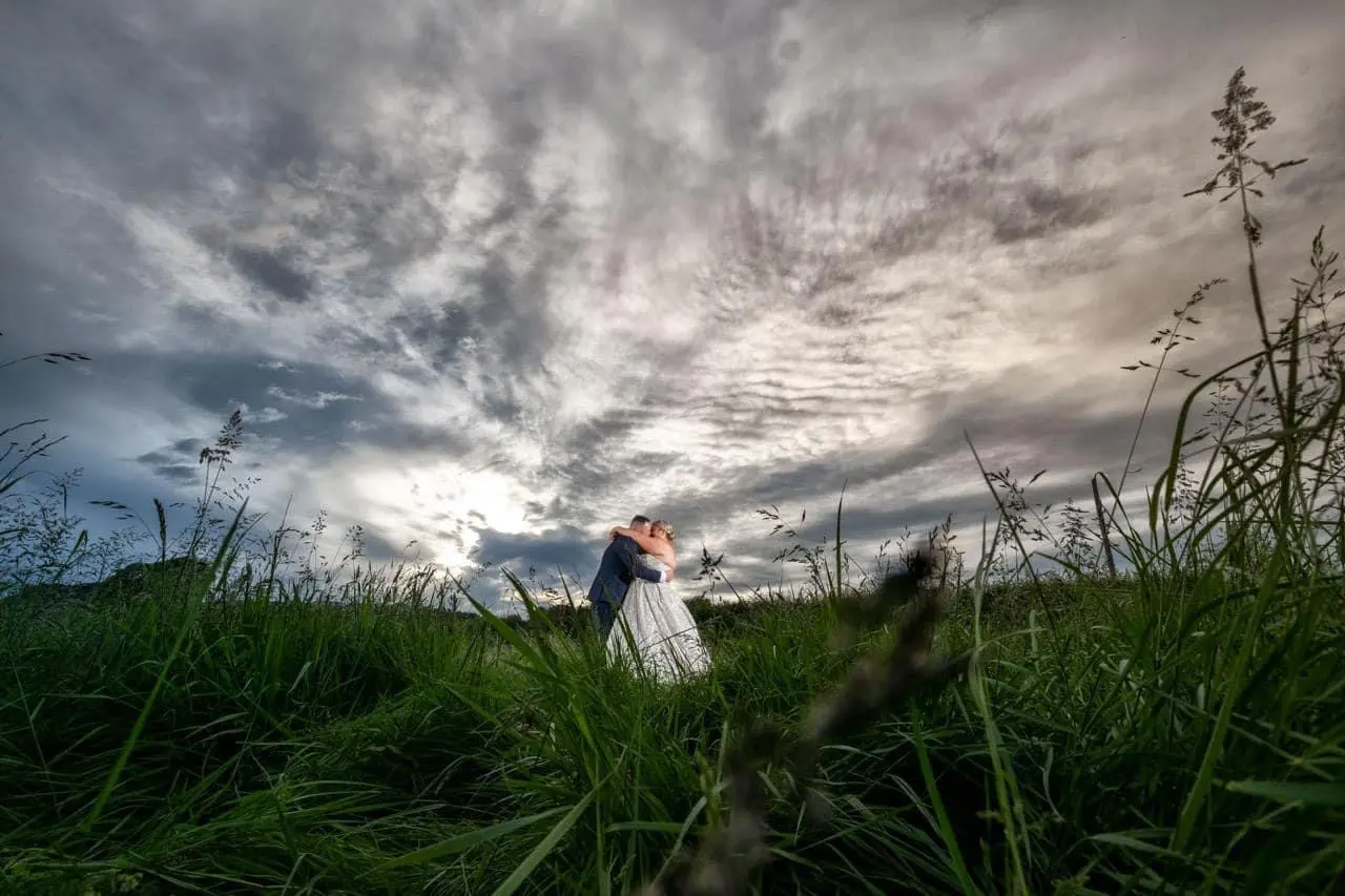 Bride wearing Anniston by Maggie Sottero kissing her husband