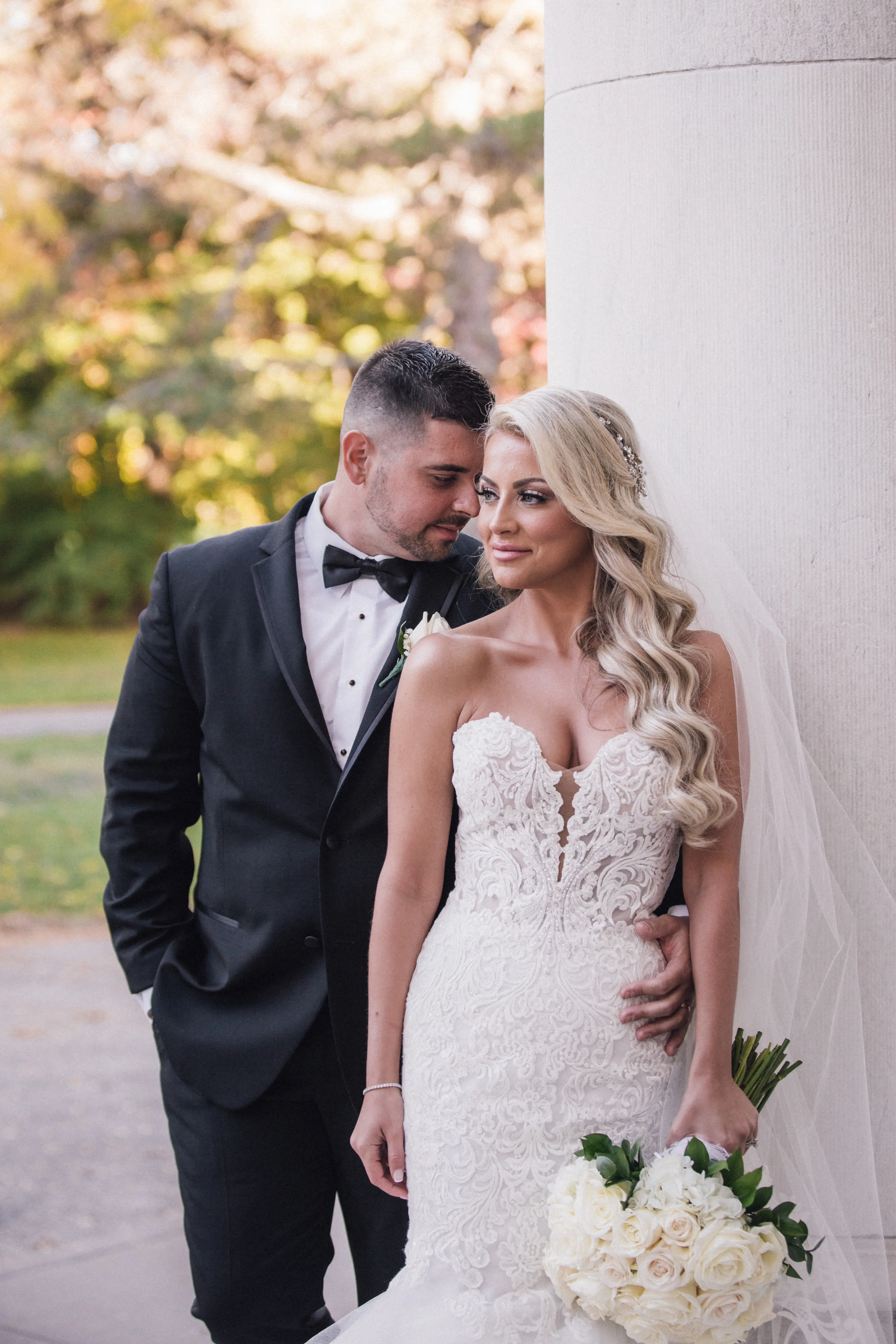 Bride Wearing Lace Mermaid Wedding Dress Called Alistaire By Maggie Sottero With Groom Holding A White Rose Bouquet
