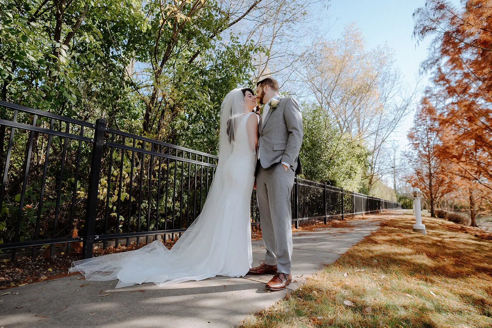 Bride Wearing Simple Wedding Dress Called Theodora By Rebecca Ingram About To Kiss Groom