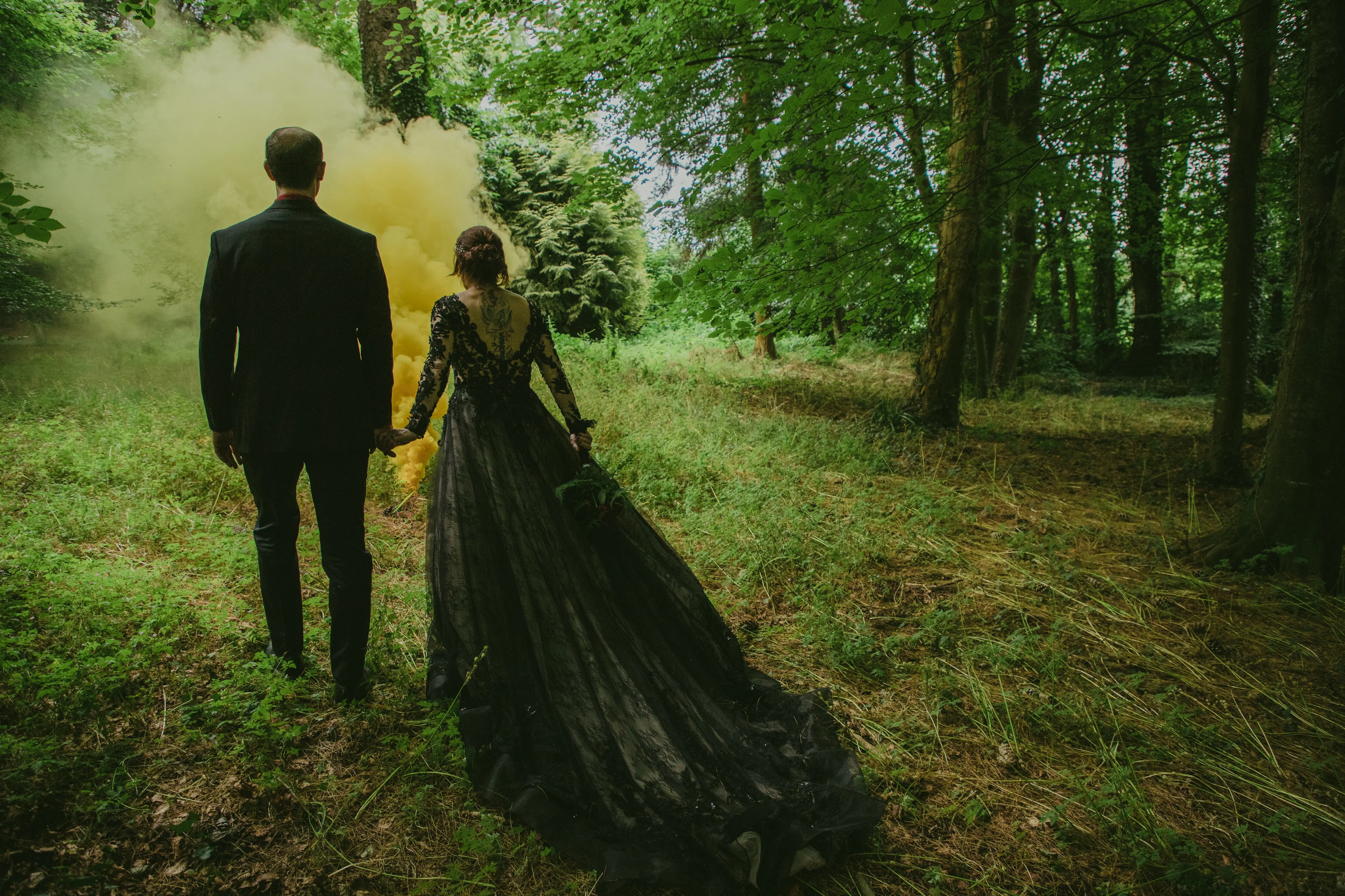 Bride wearing Zander wedding dress by Sottero and Midgley walking with her husband
