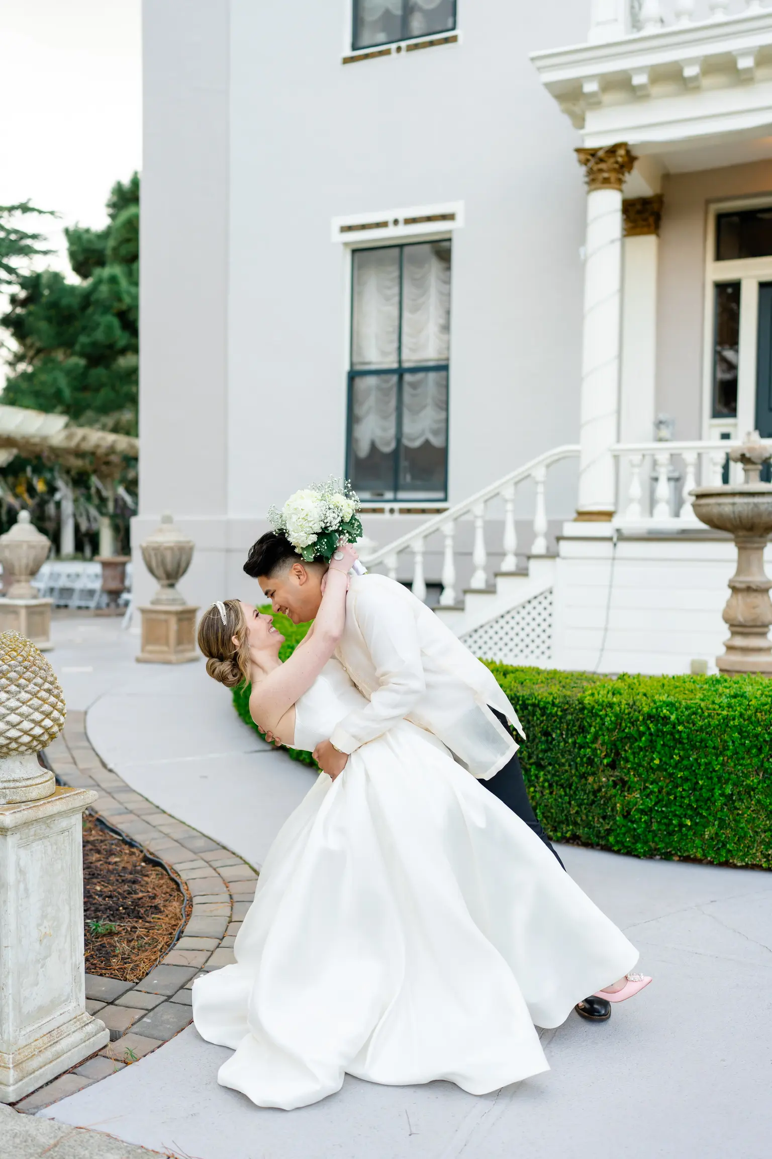Bride wearing Selena by Maggie Sottero being dipped by her husband