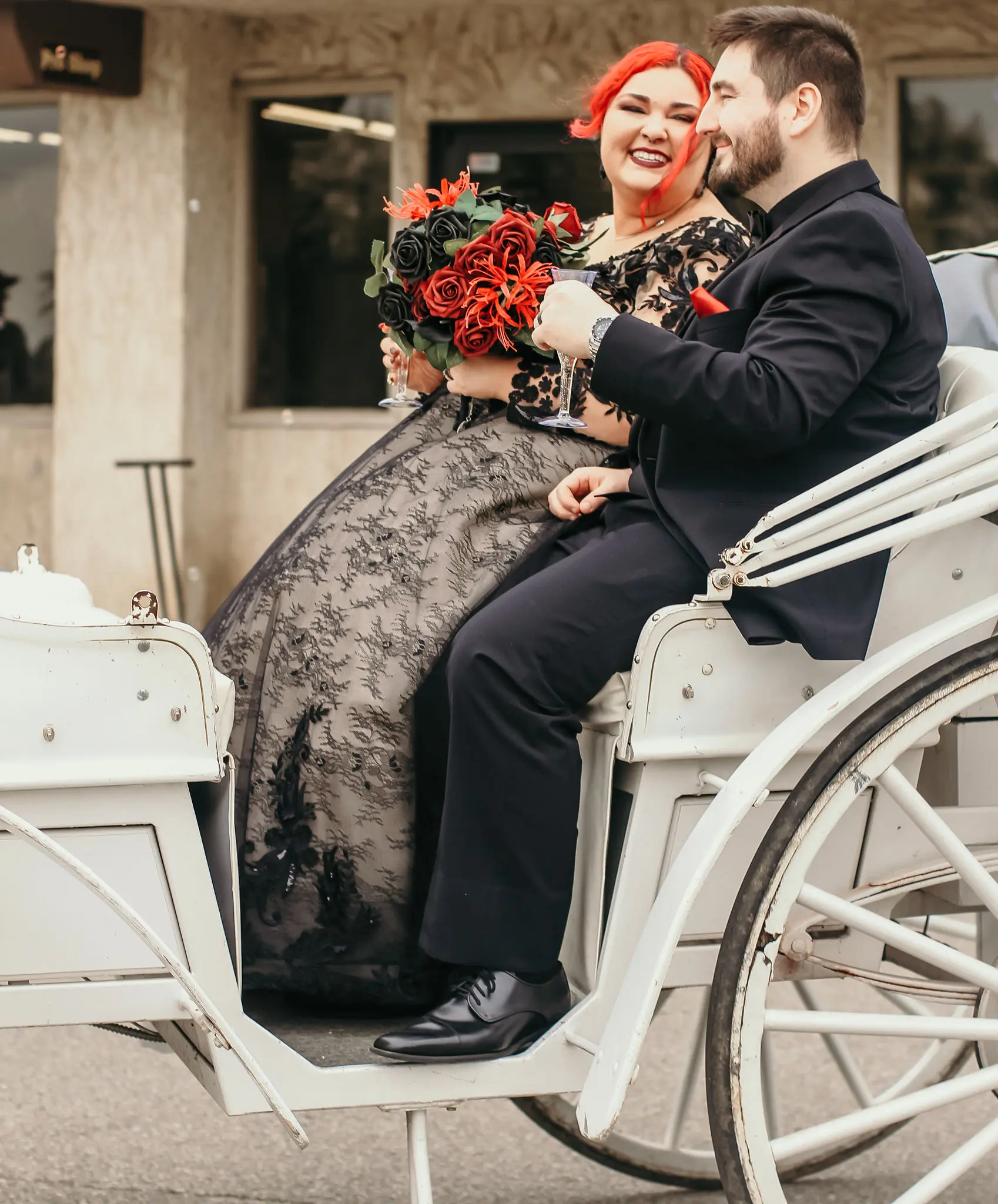 Groom In Carriage With Bride In Black Lace Ball Gown Wedding Dress Called Zander By Sottero And Midgley Holding A Red Flower Bouquet