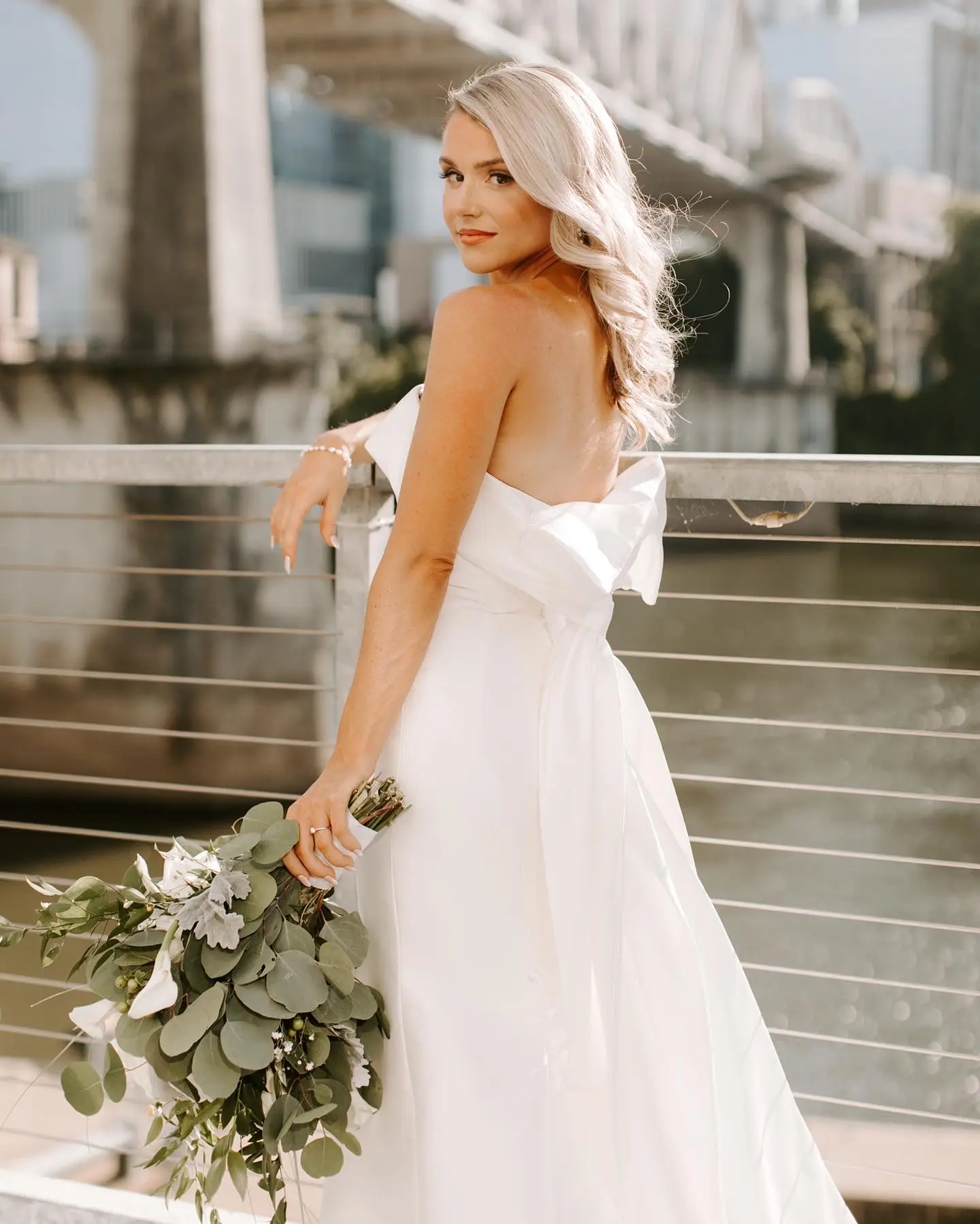 Bride Wearing Unique Strapless Wedding Dress With Beautiful Back Bow Mitchell By Maggie Sottero